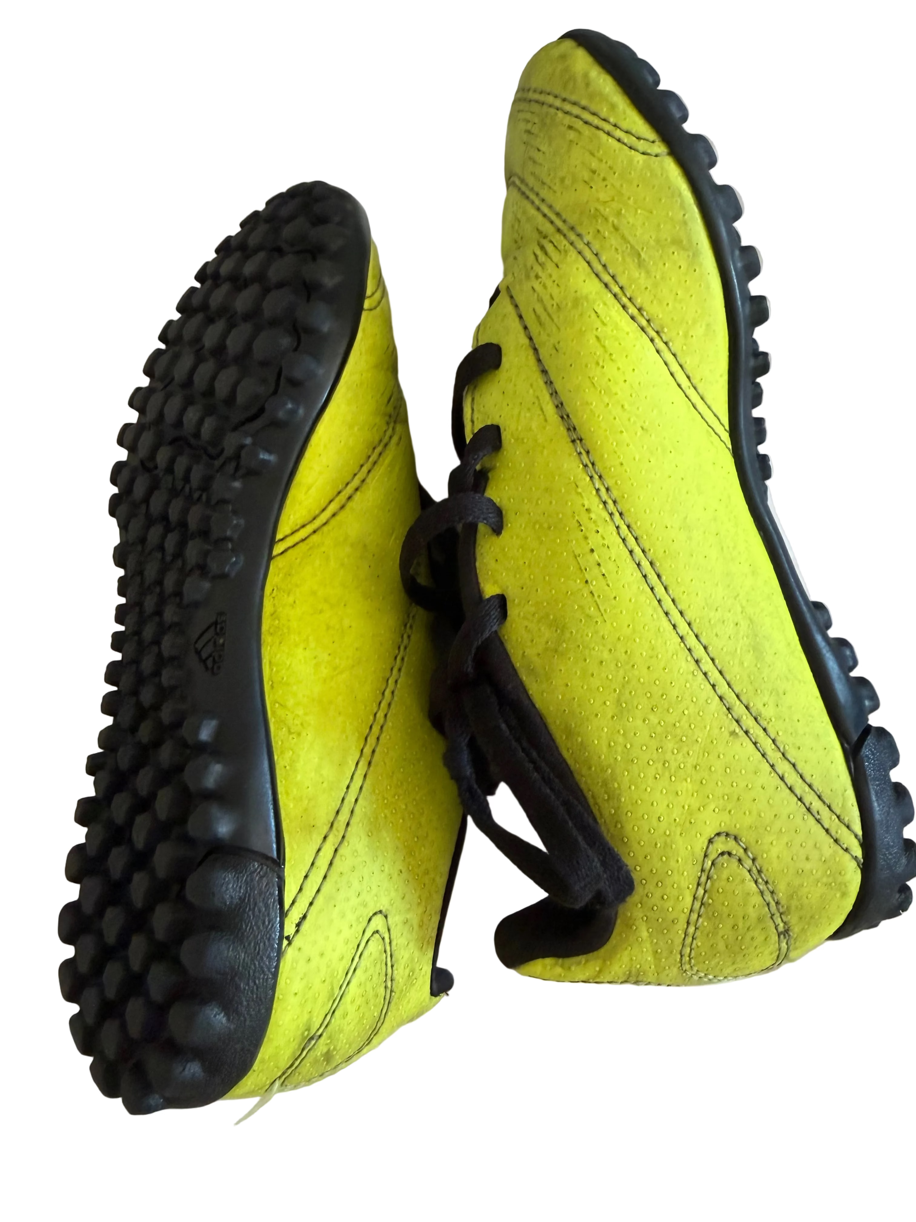 Yellow and black adidas Predator boots positioned to show heel and sole design