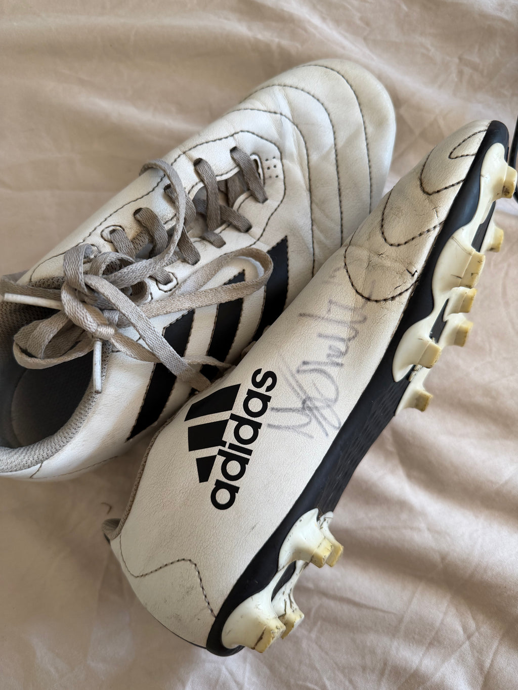 adidas white football boots with black sole and signature on side
