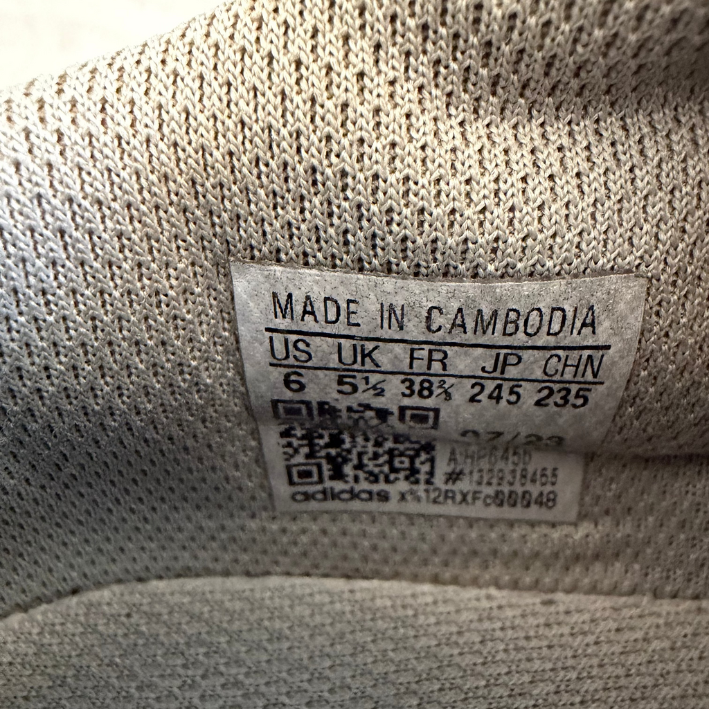 Size label inside adidas football boot with sizing details and barcode