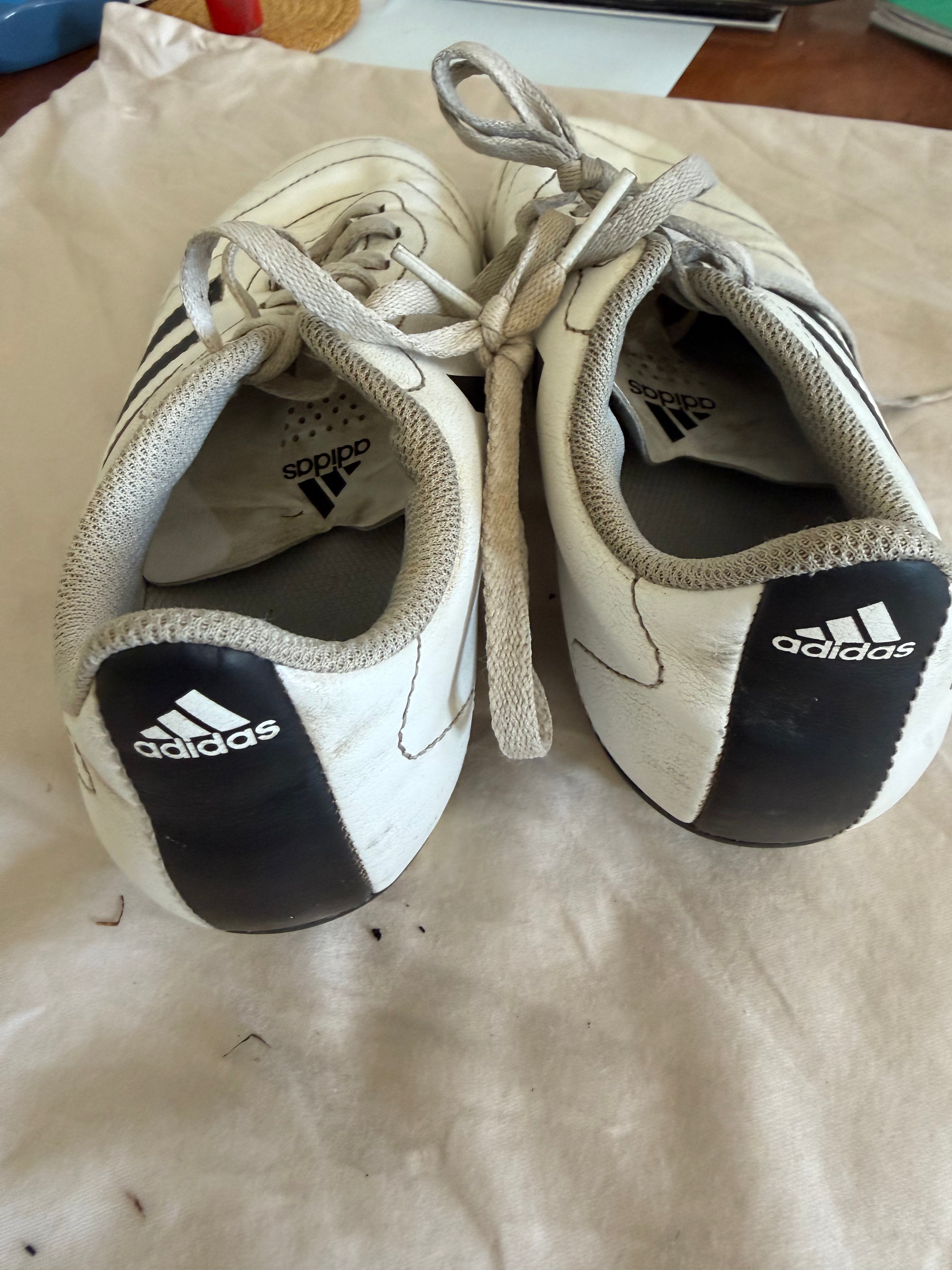 Back view of adidas white football boots showing logos and heels