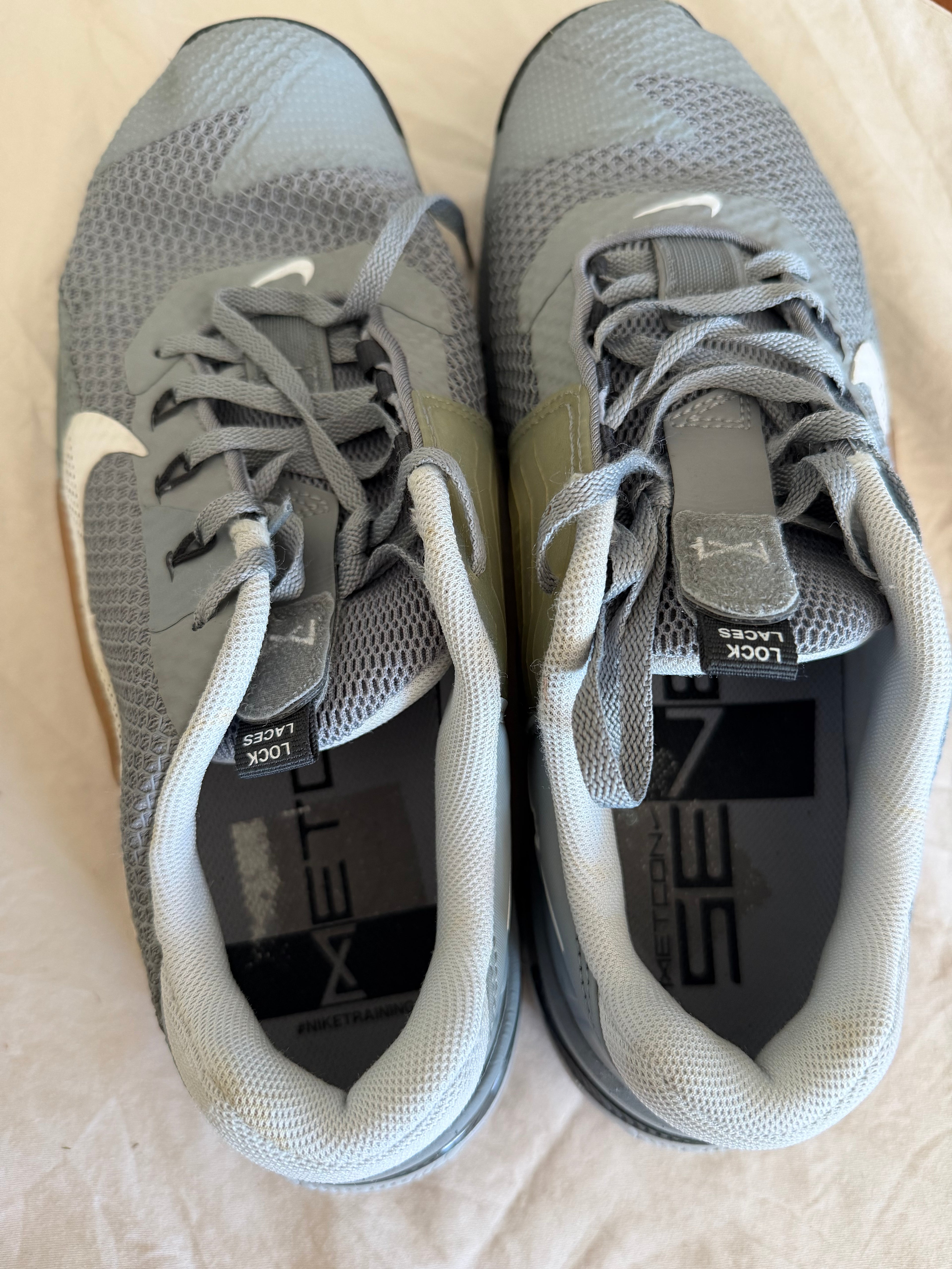Pair of Nike Metcon 7 trainers in grey with lock laces, top view