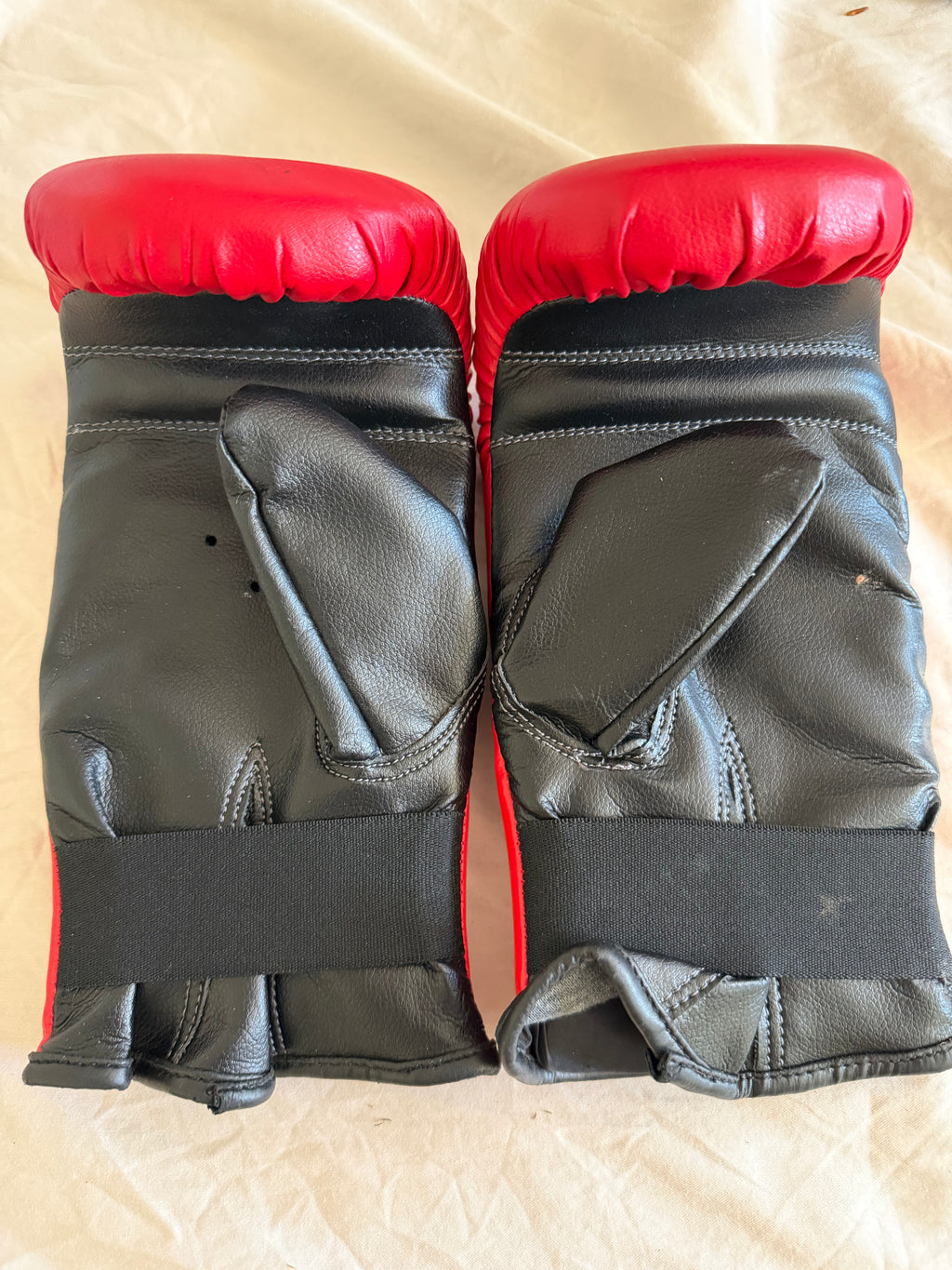Back view of MadX boxing gloves showing black palm and elastic wrist strap
