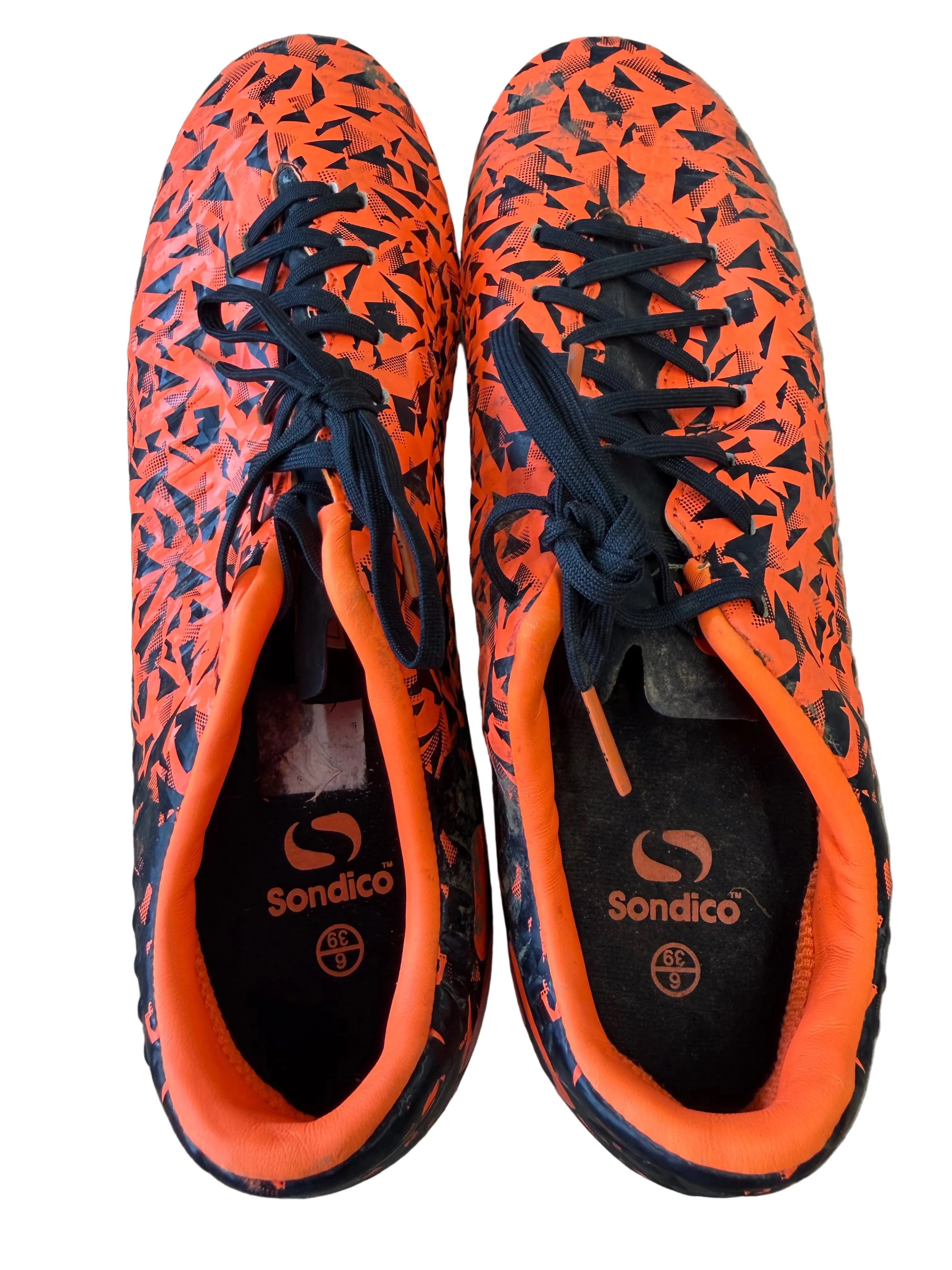 Pair of Sondico Blaze football boots with black and orange geometric pattern, top view