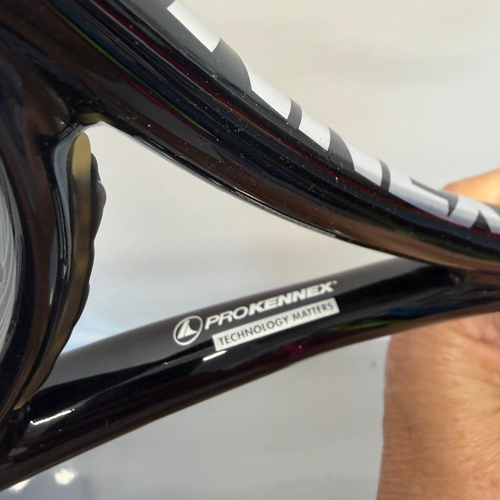 Close-up of ProKennex brand and Technology Matters printed on tennis racket throat