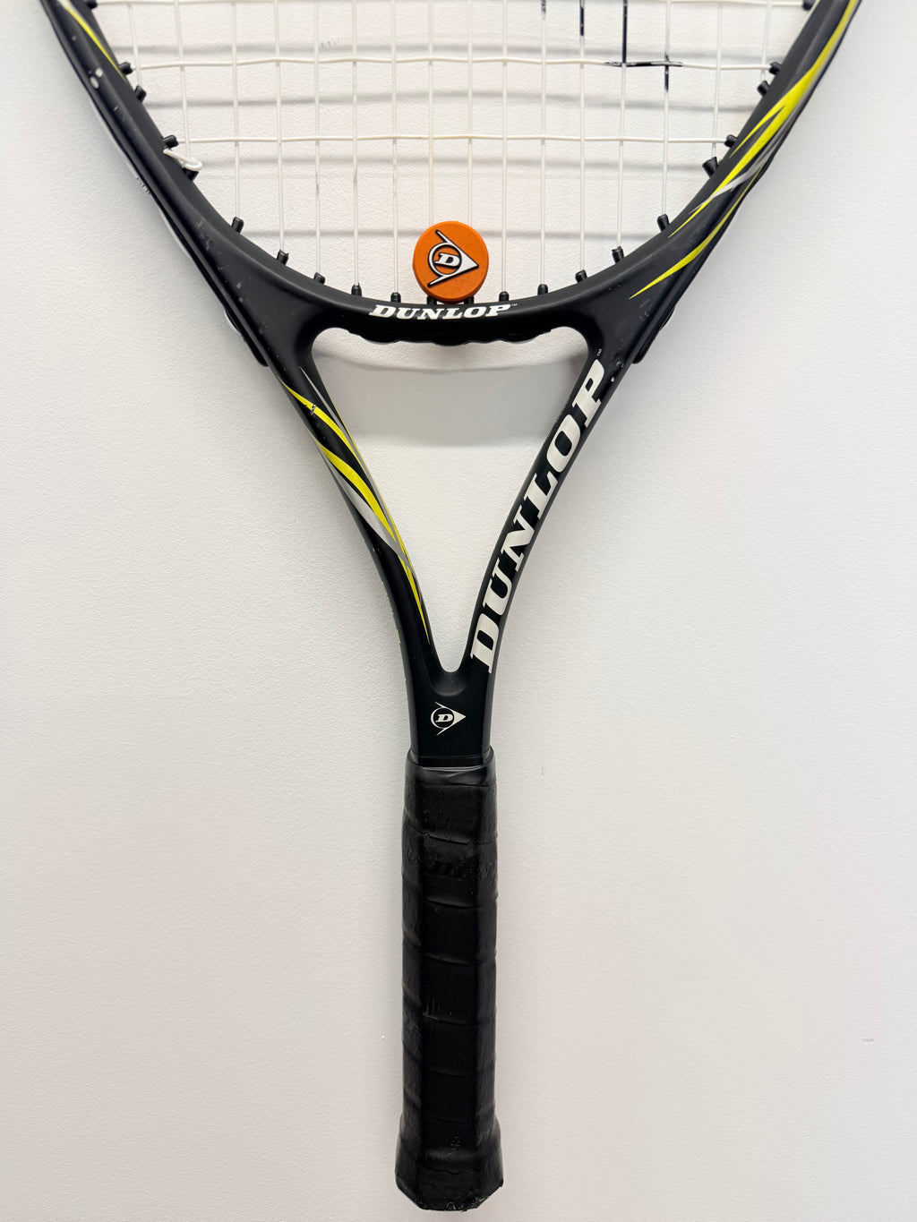 Close-up of Dunlop Fury G100 tennis racket handle and strings