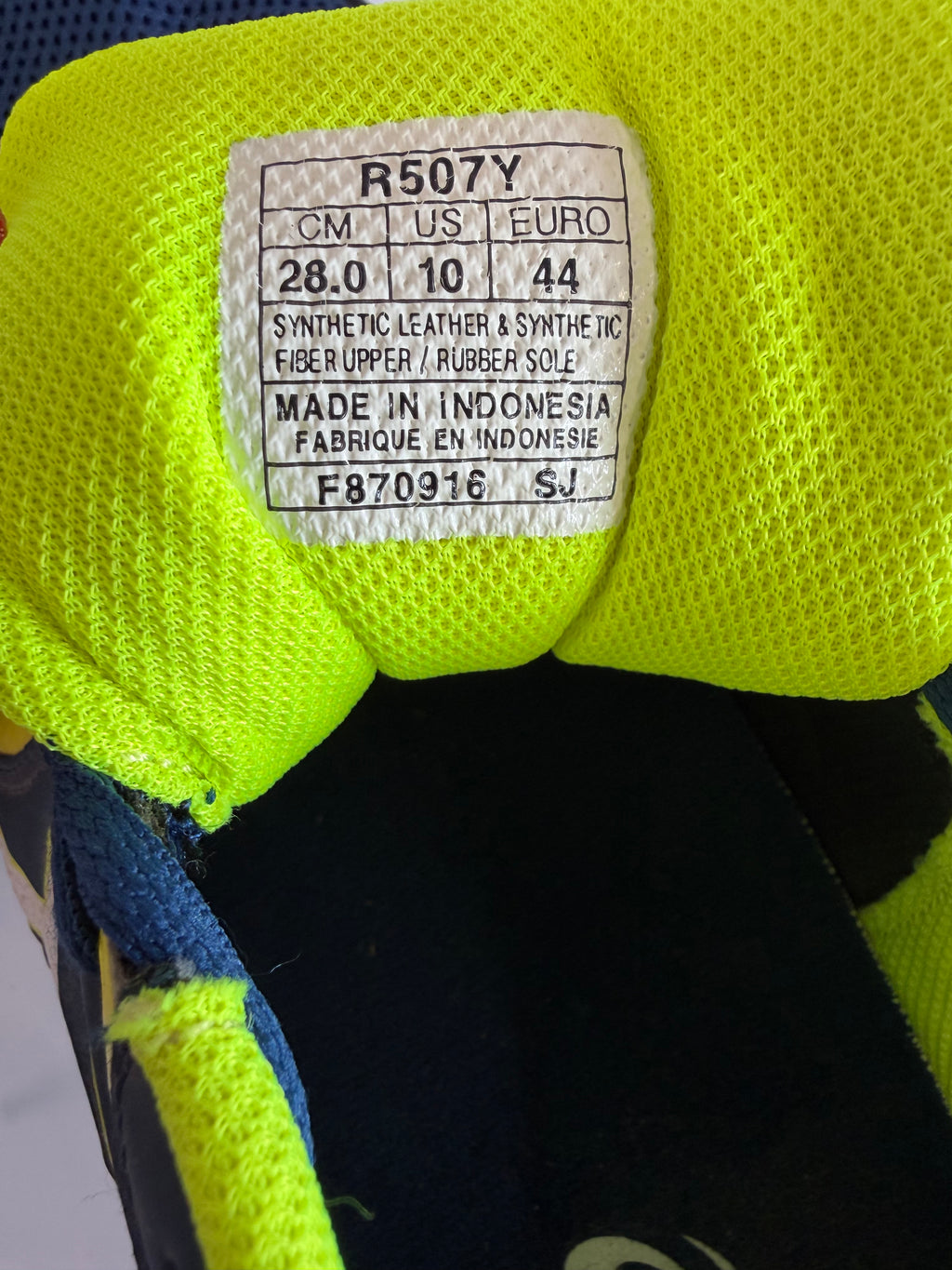 Size and material label inside ASICS trainer tongue