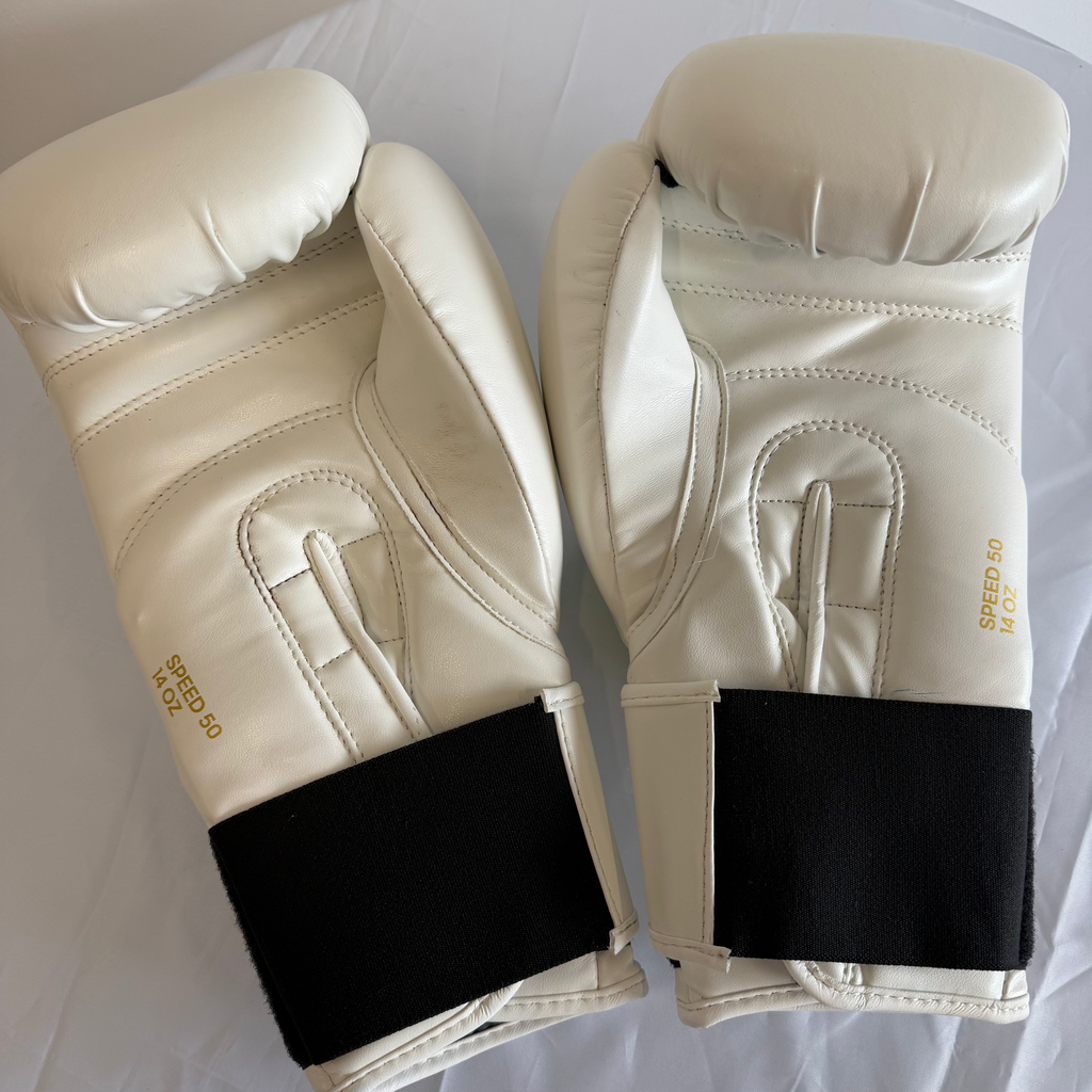 Back view of adidas boxing gloves showcasing padding, wrist area, and SPEED 50 label