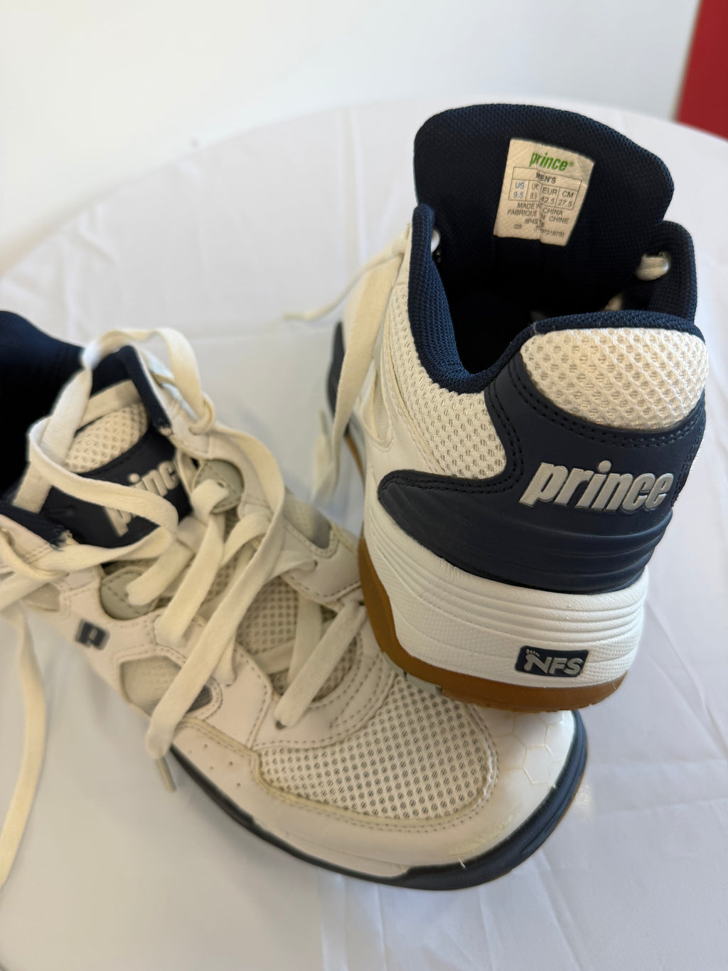 Rear and angled view of Prince trainers showing heel branding and gum soles