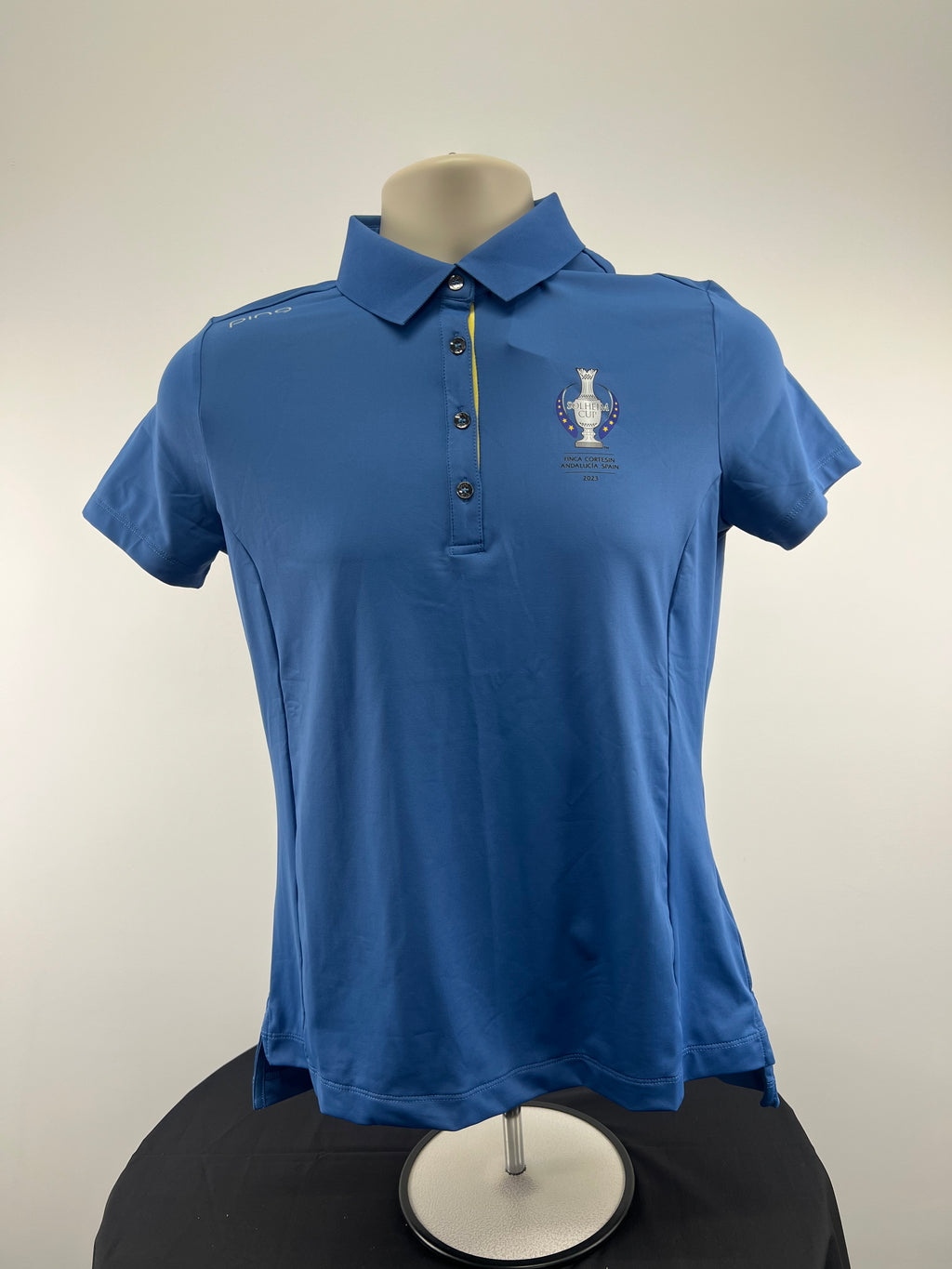 Front of horizon blue women's Ping Solheim Cup 2023 Spain polo shirt, size 10, on a mannequin