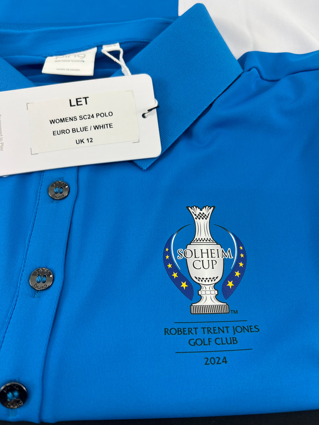 Close-up of Solheim Cup 2024 logo and size tag on Women's Ping Golf Polo