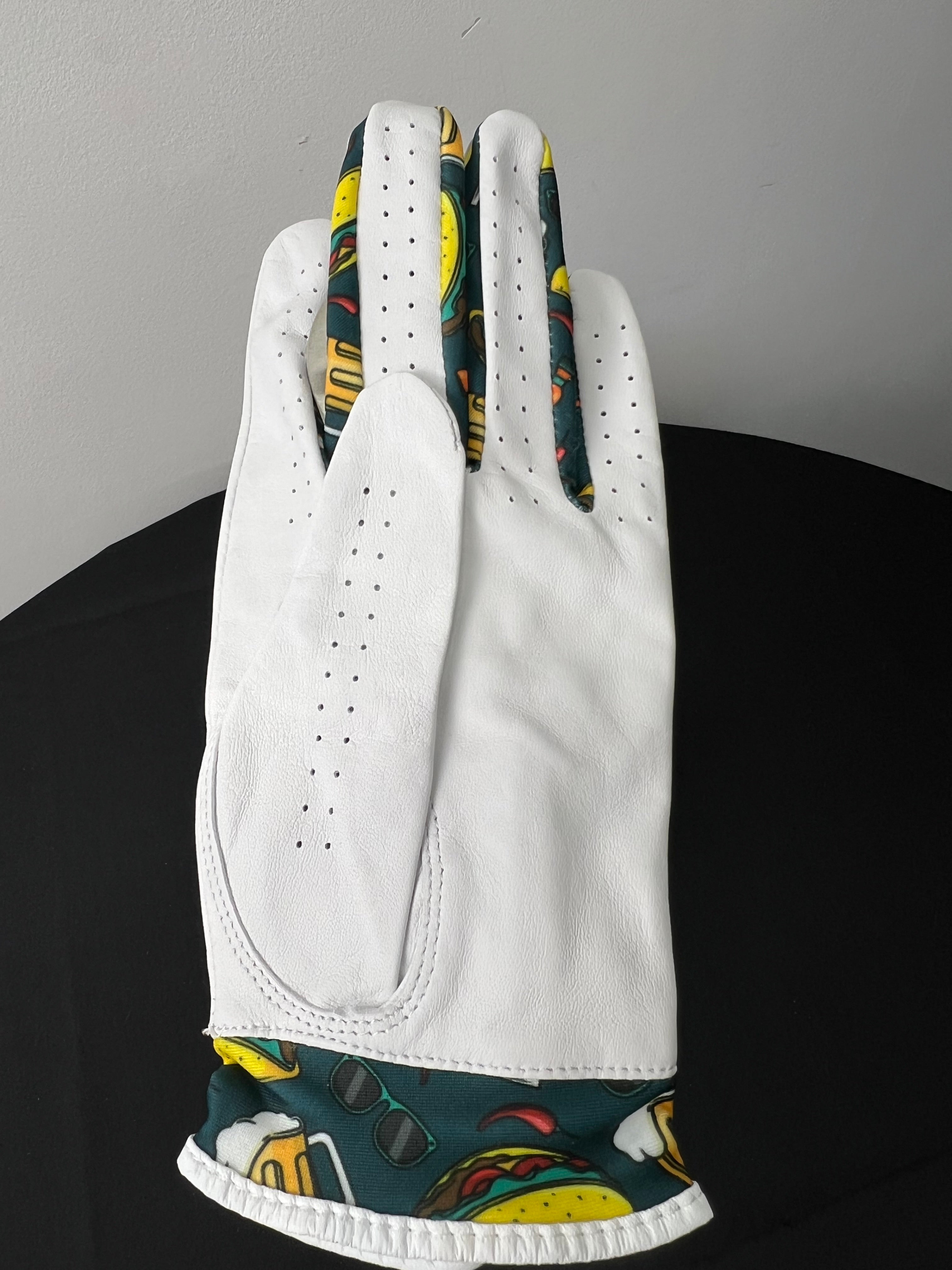 Back view of women's white golf glove with taco, sunglasses, and beer print at the cuff
