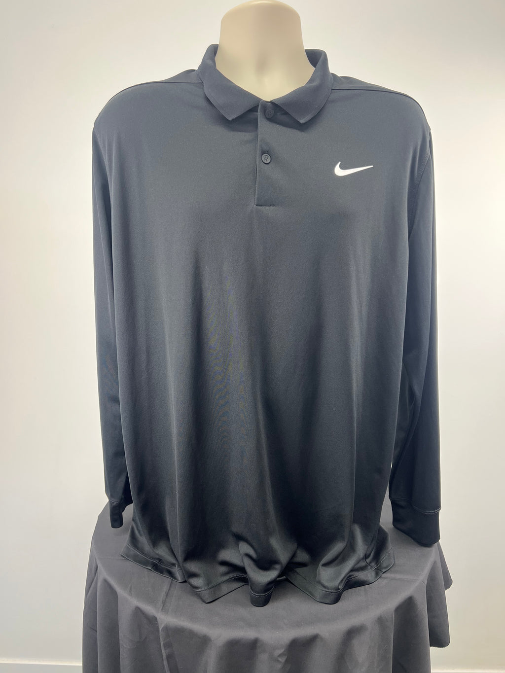 Front view of black Nike men's long sleeve golf polo in size XL