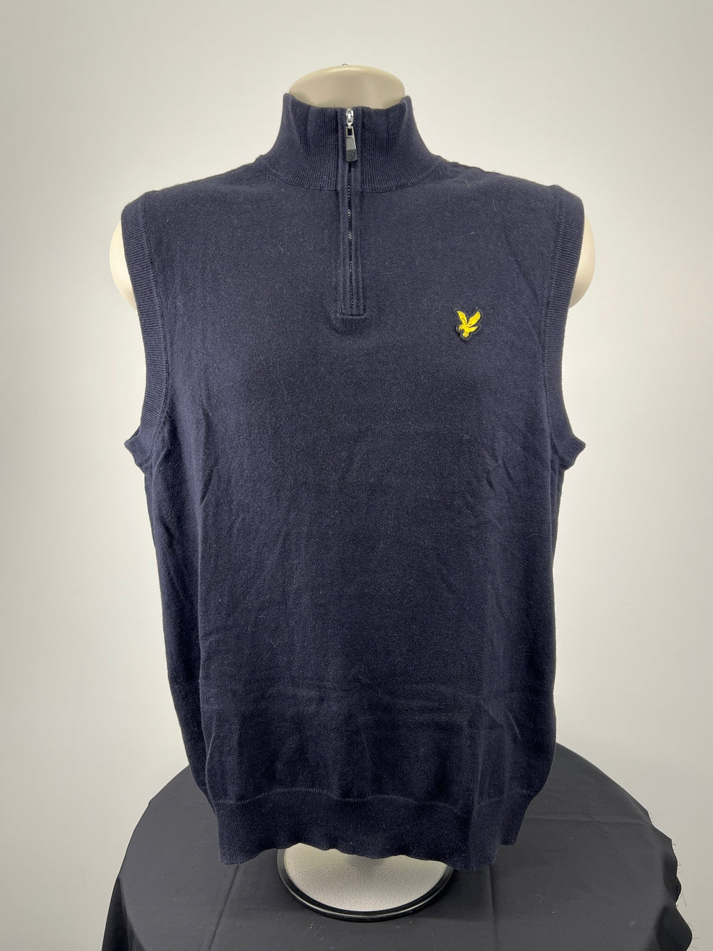 Front view of men’s navy Lyle and Scott sleeveless pullover with 1/4 zip and golden eagle logo