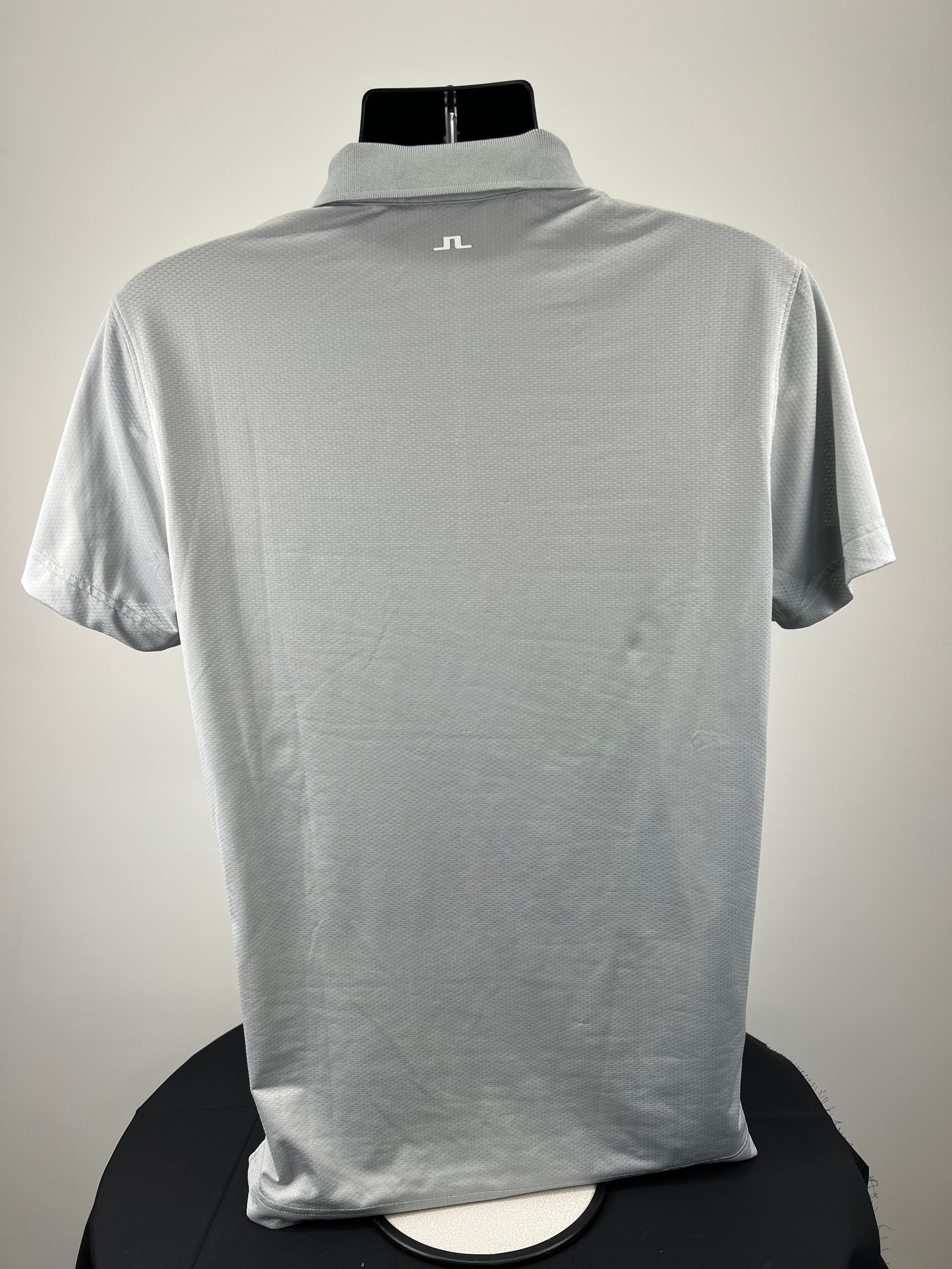 Back view of men's J.Lindeberg grey polo shirt on black mannequin highlighting logo on back collar