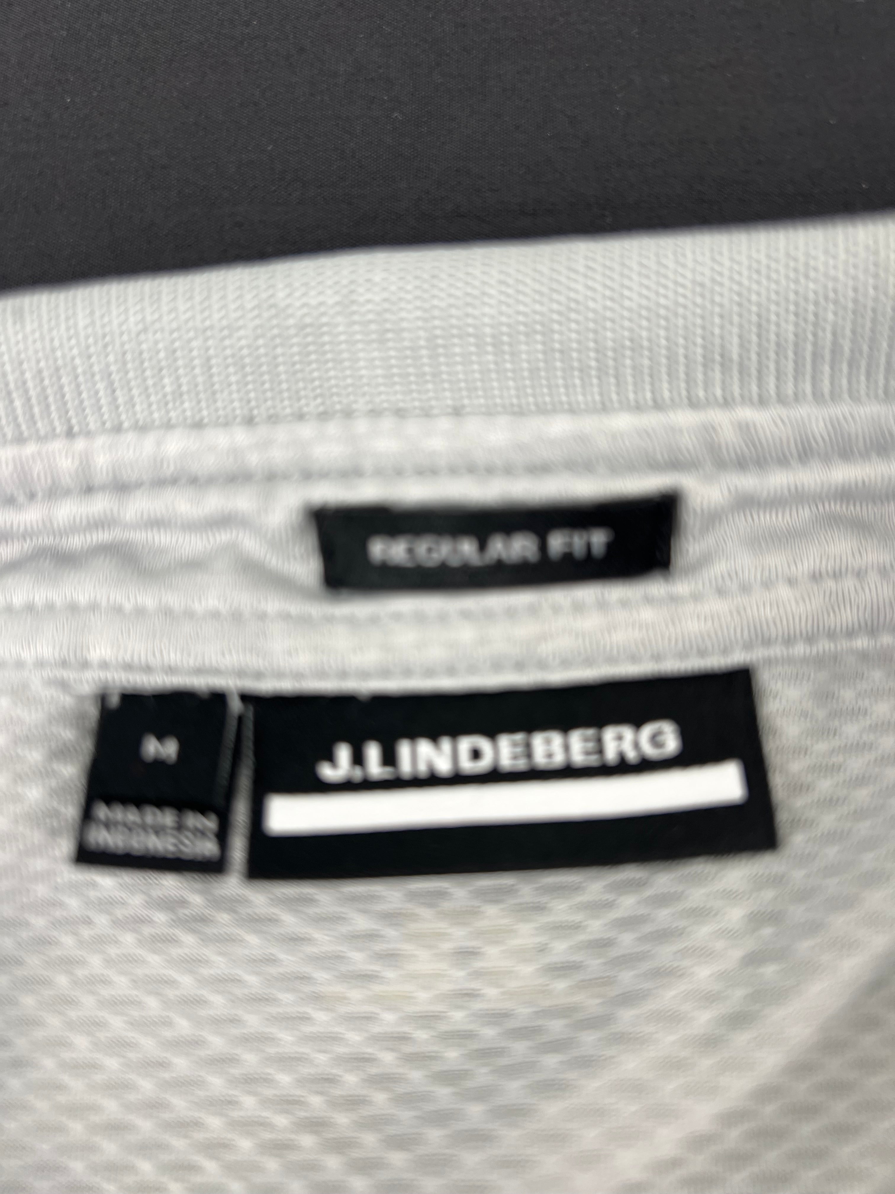 Close-up of J.Lindeberg label and regular fit tag inside the grey polo shirt collar