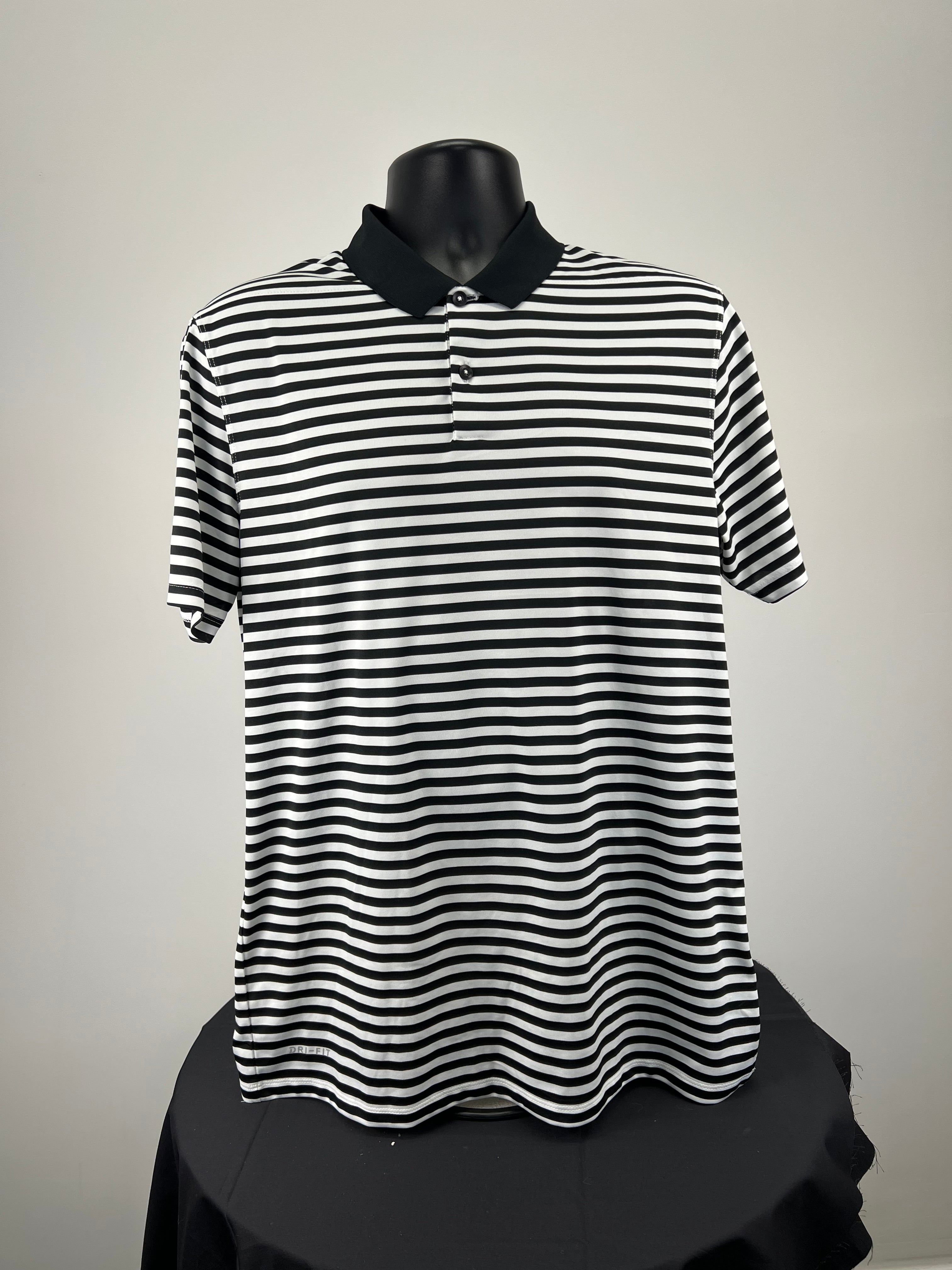 Front view of Men’s Nike black and white striped golf polo with black collar