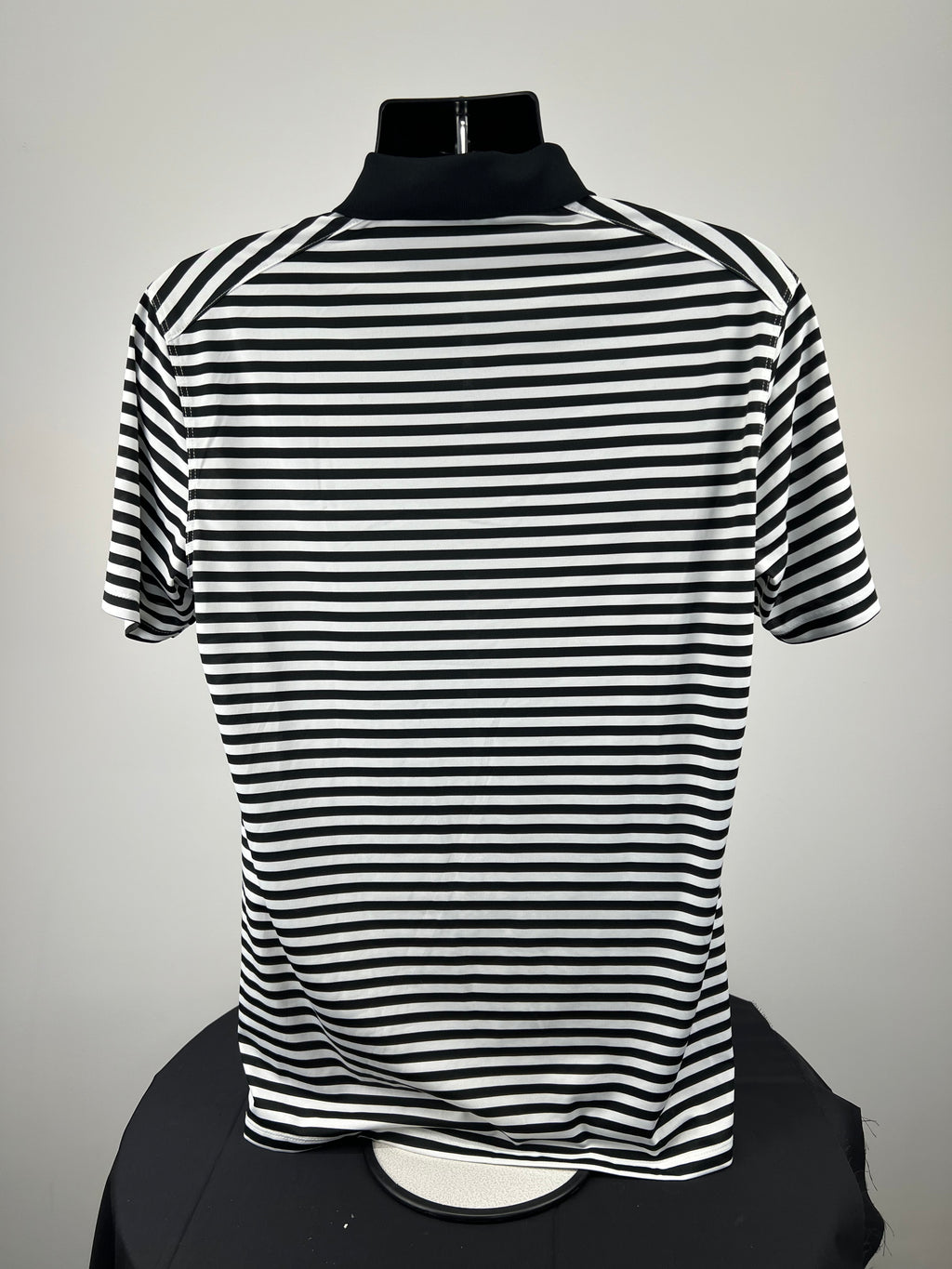 Back view of Men’s Nike black and white striped golf polo shirt