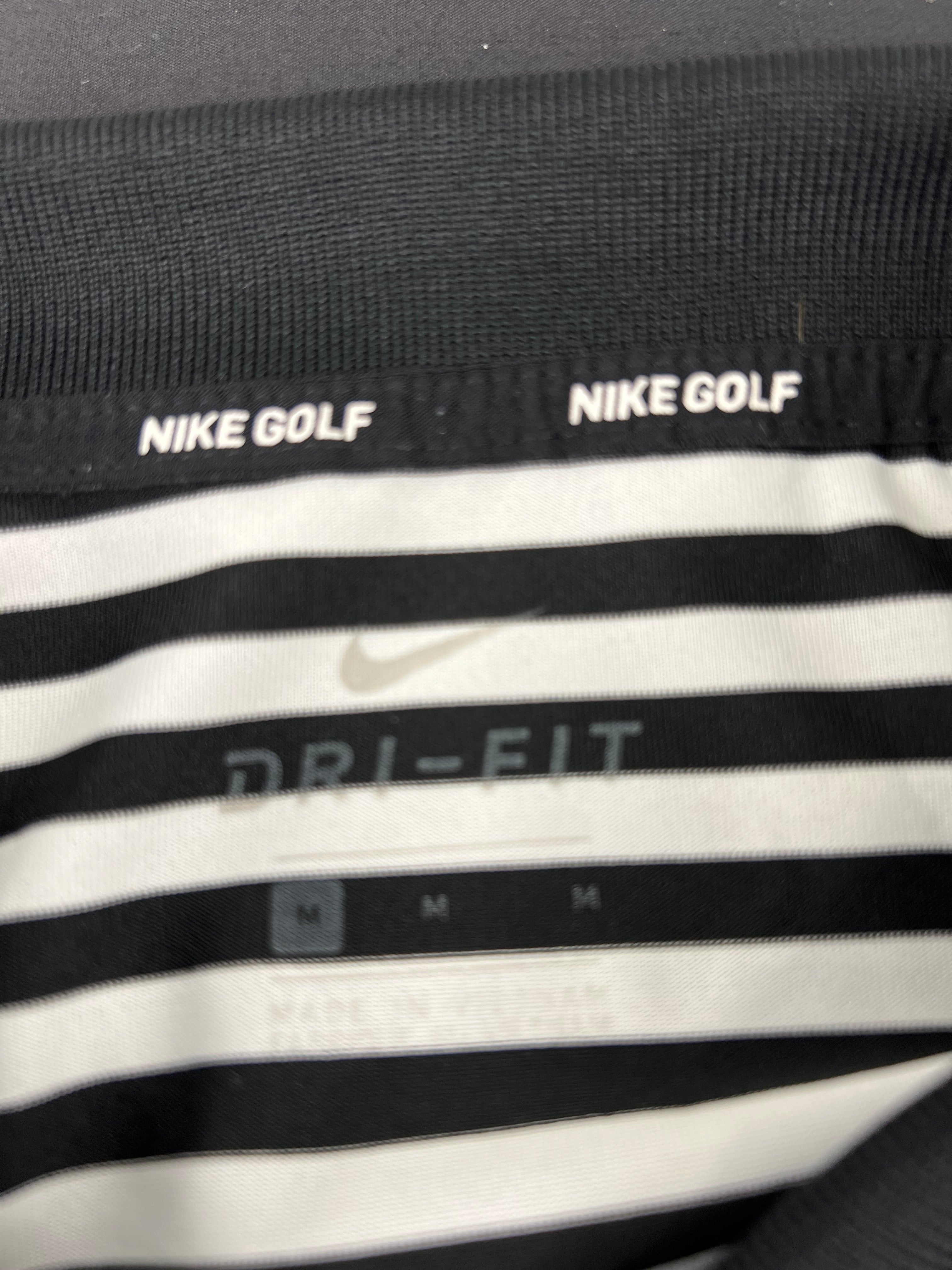 Close-up detail of Nike Golf Dri-FIT label inside the polo shirt