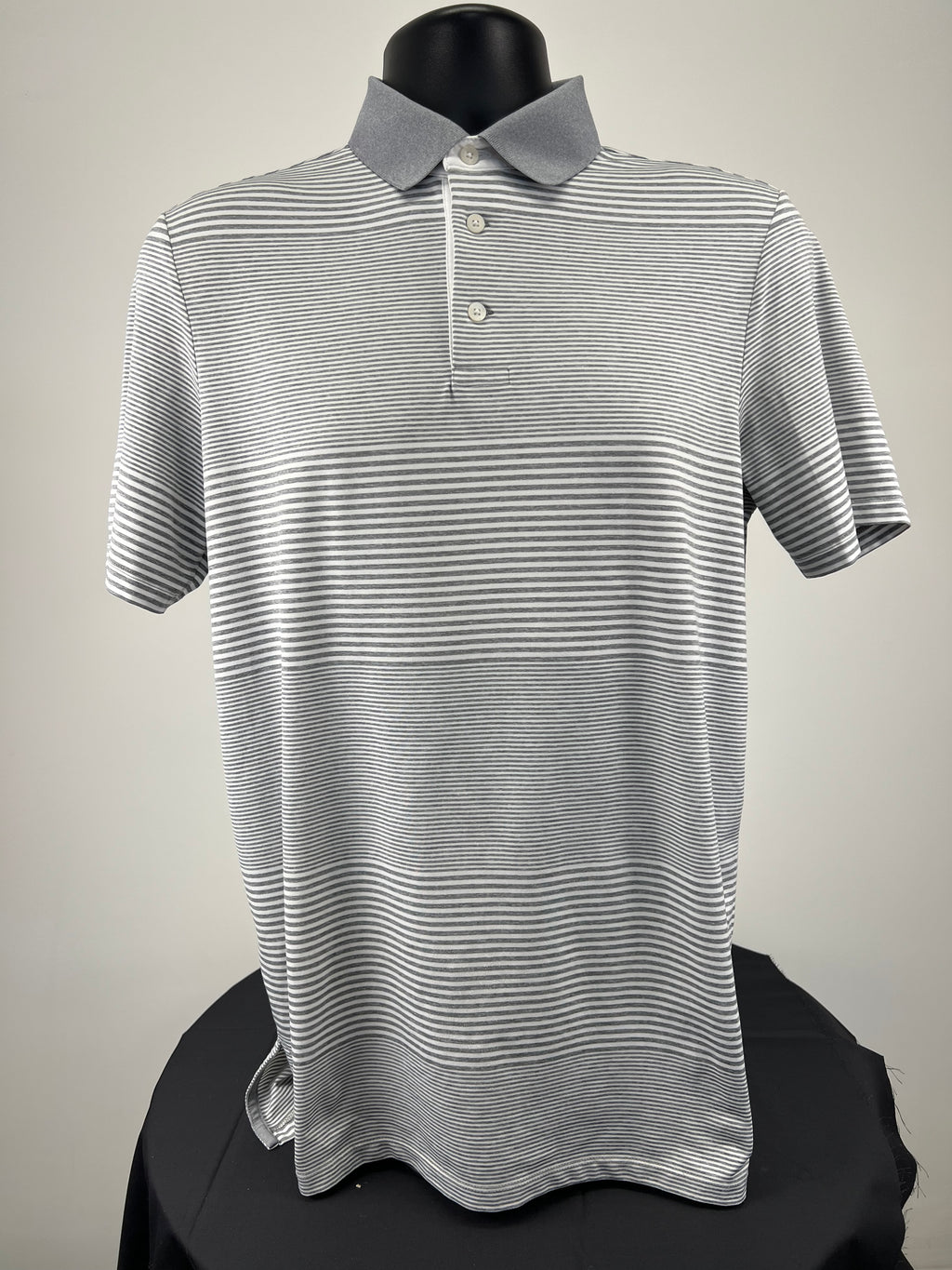 Front view of men’s Ralph Lauren RLX polo shirt in grey and white stripes with grey collar and three-button placket