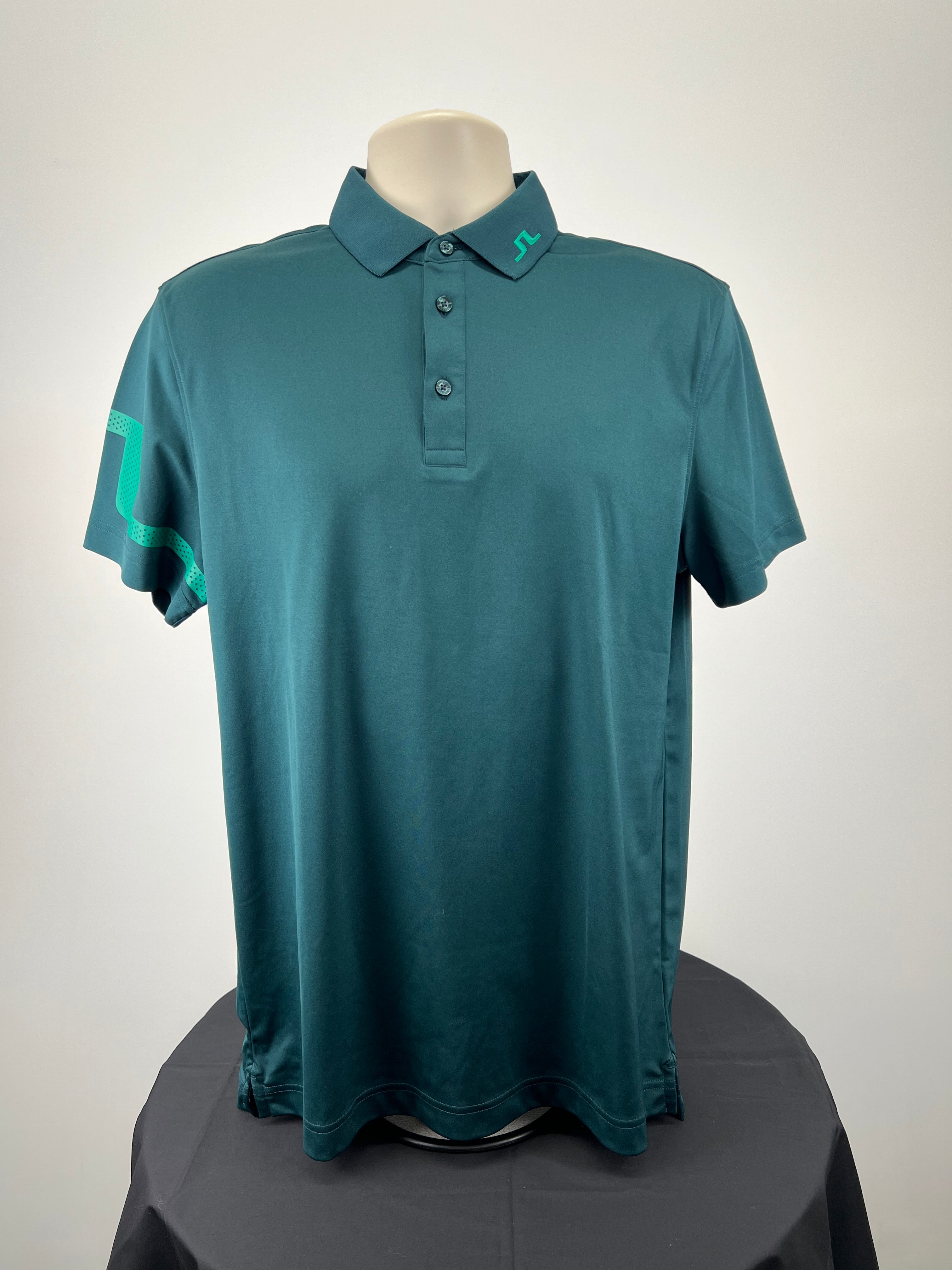 Front view of men’s dark green J. Lindeberg polo shirt with teal logo on collar