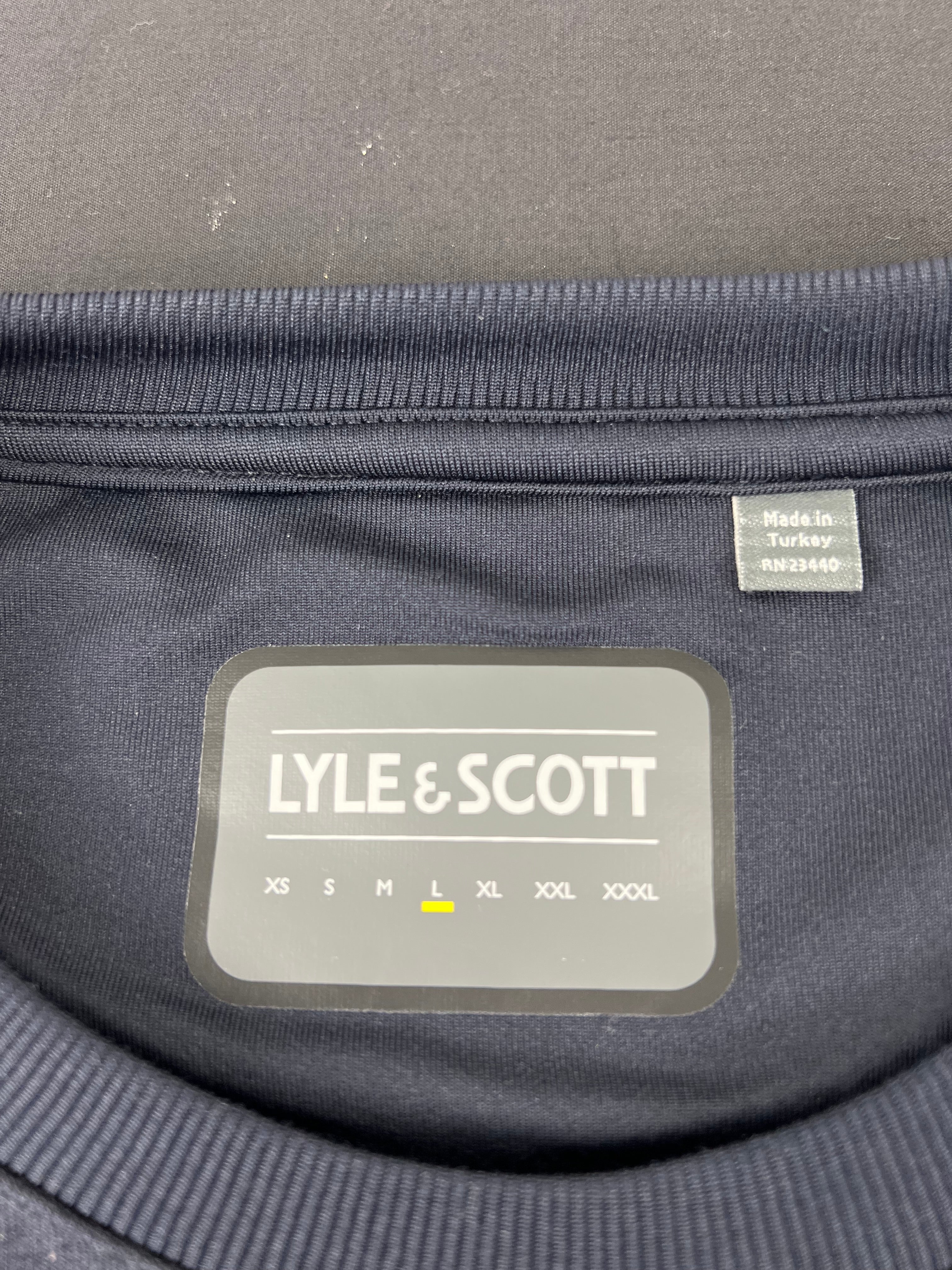 Close-up of Lyle and Scott label inside collar indicating size L and made in Turkey