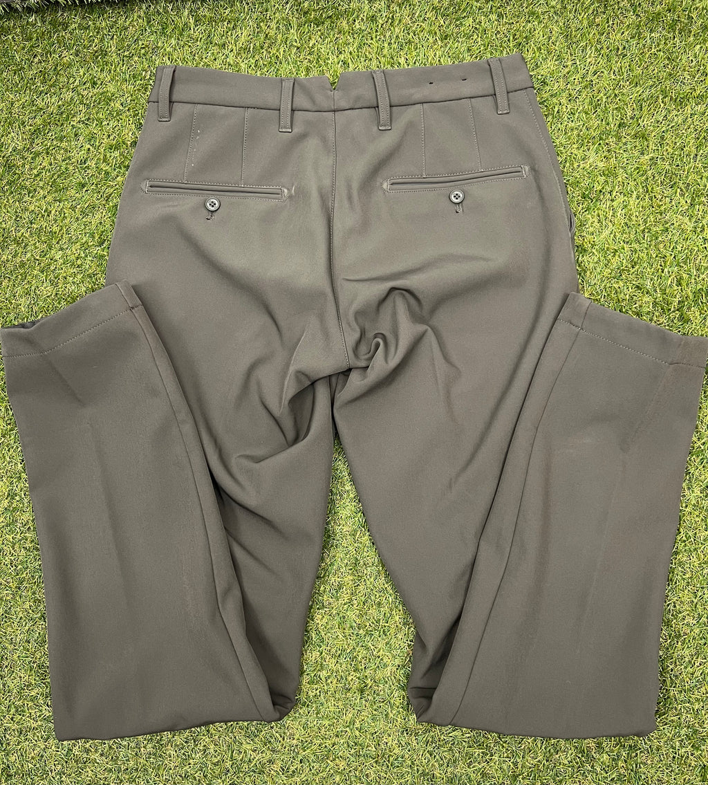 Back view of men’s J.Lindeberg Ellott khaki bonded fleece trousers with button pockets and belt loops on grass