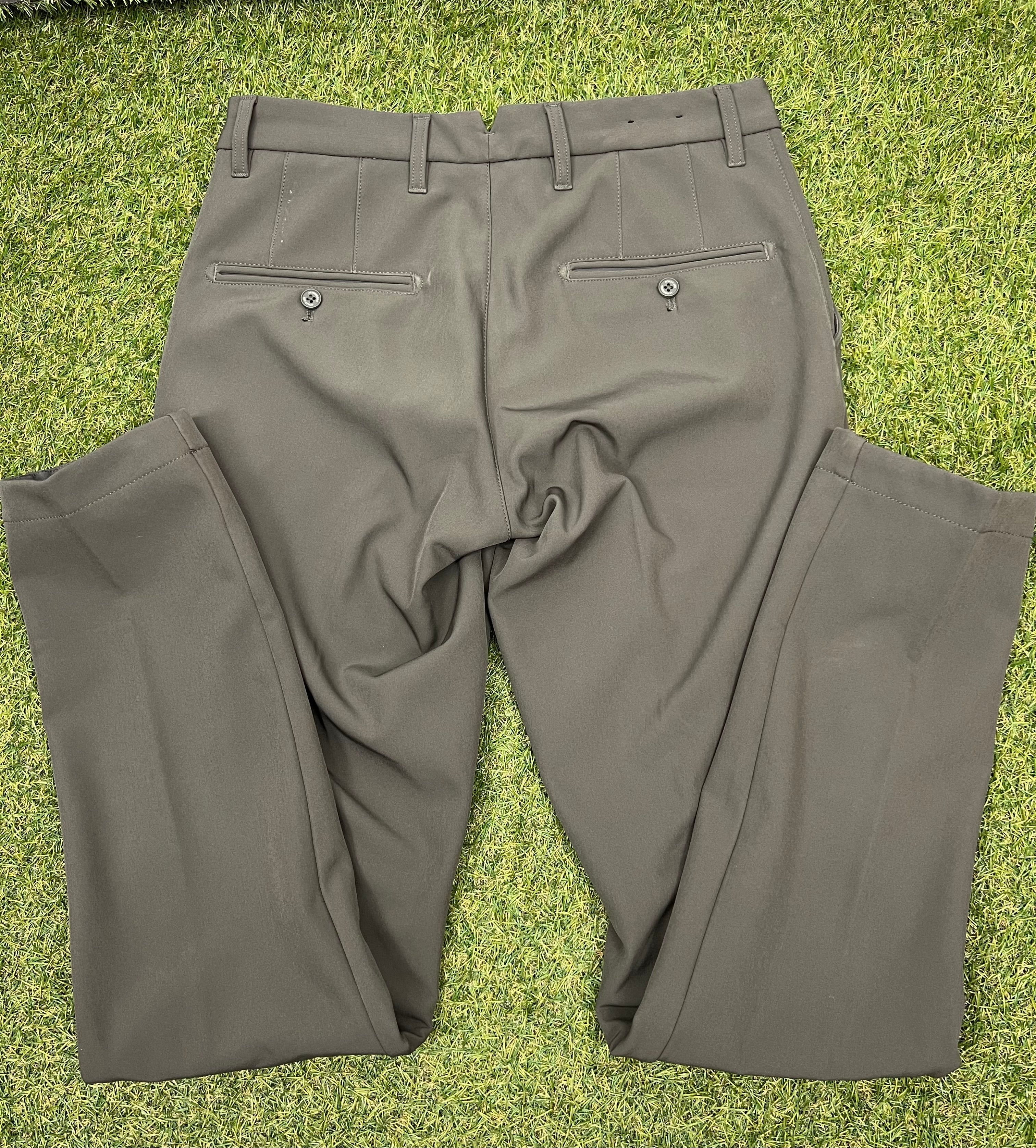 Back view of men’s J.Lindeberg Ellott khaki bonded fleece trousers with button pockets and belt loops on grass