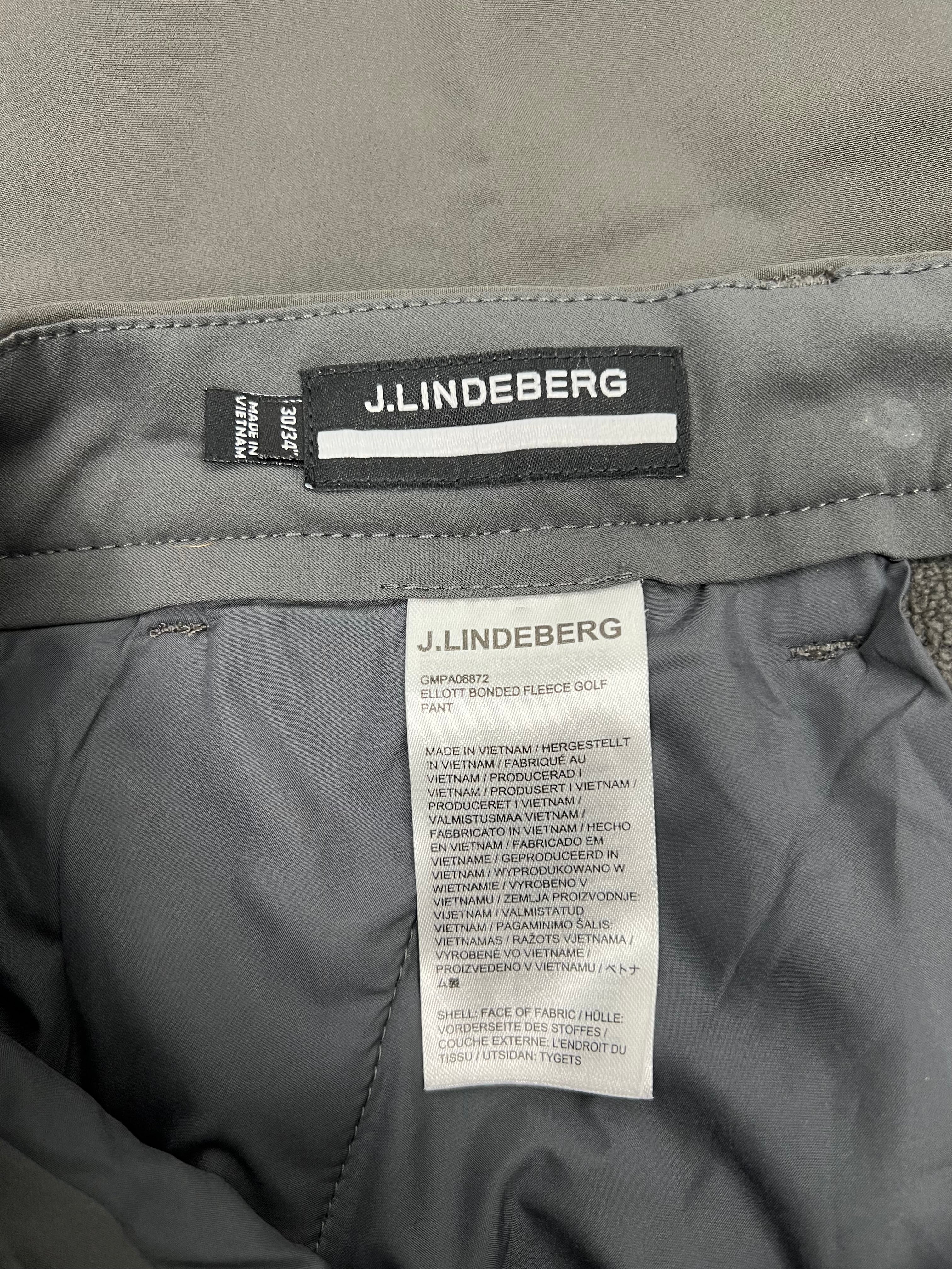 Inside label and care tag of J.Lindeberg Ellott bonded fleece trousers in khaki showing size 30/34 and fabric details