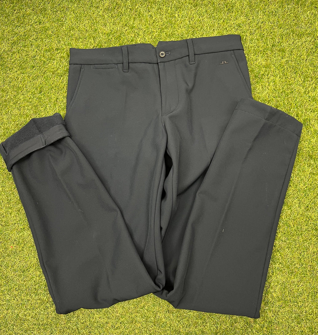 Front view of navy J.Lindeberg Ellott bonded fleece men's trousers size 30/34 on green grass
