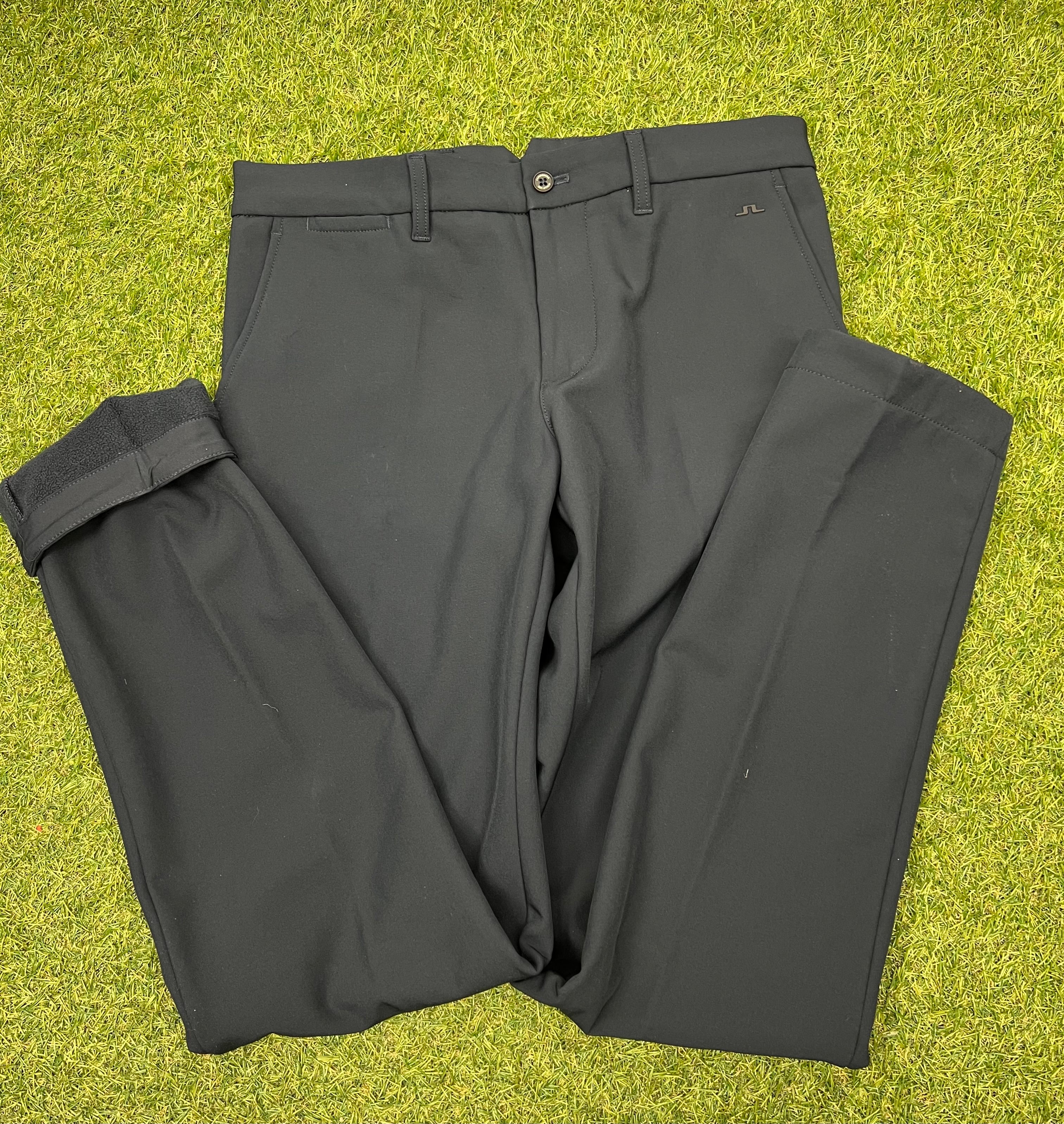 Front view of navy J.Lindeberg Ellott bonded fleece men's trousers size 30/34 on green grass