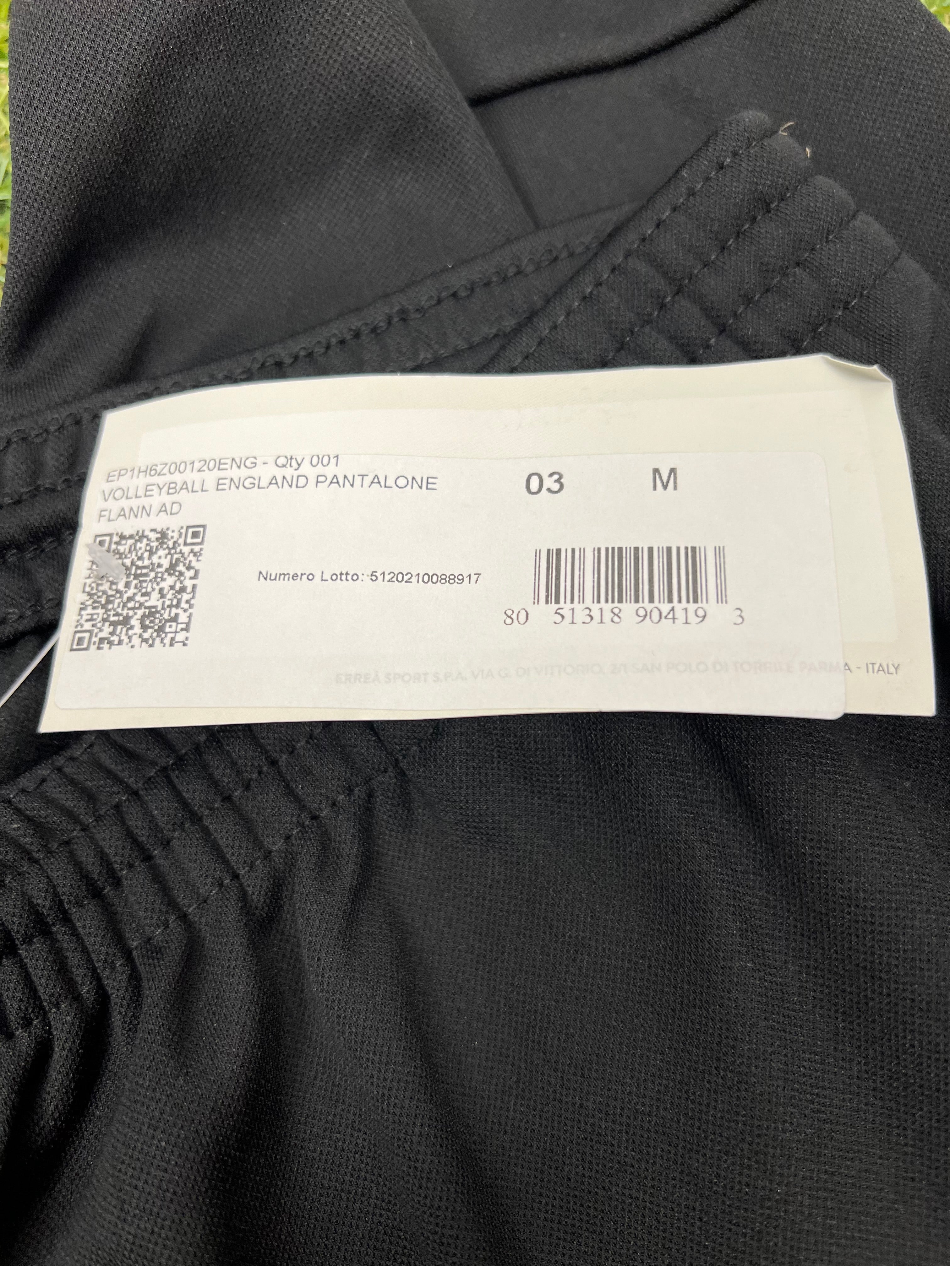 Close-up of size and product label on waistband of black England volleyball tracksuit bottoms