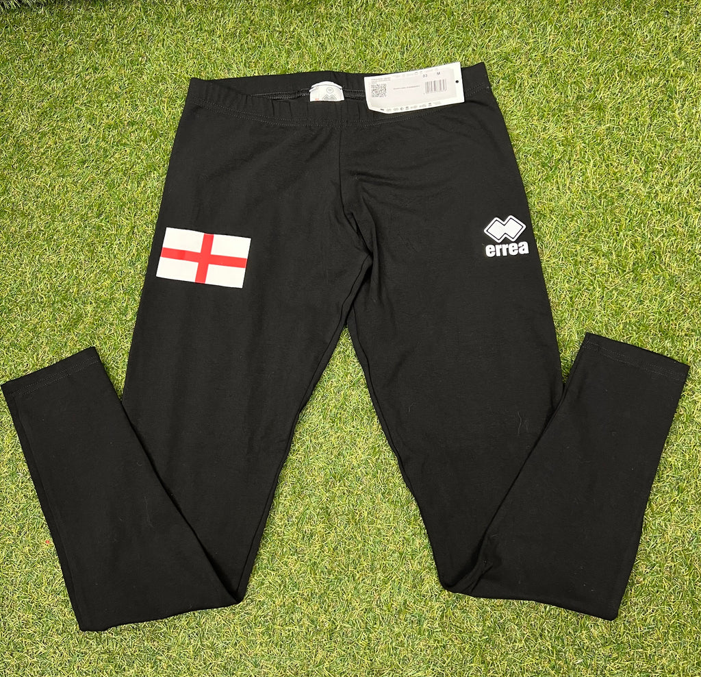 Front view of black women's leggings with England flag on left thigh and Errea logo on right thigh laid flat on grass