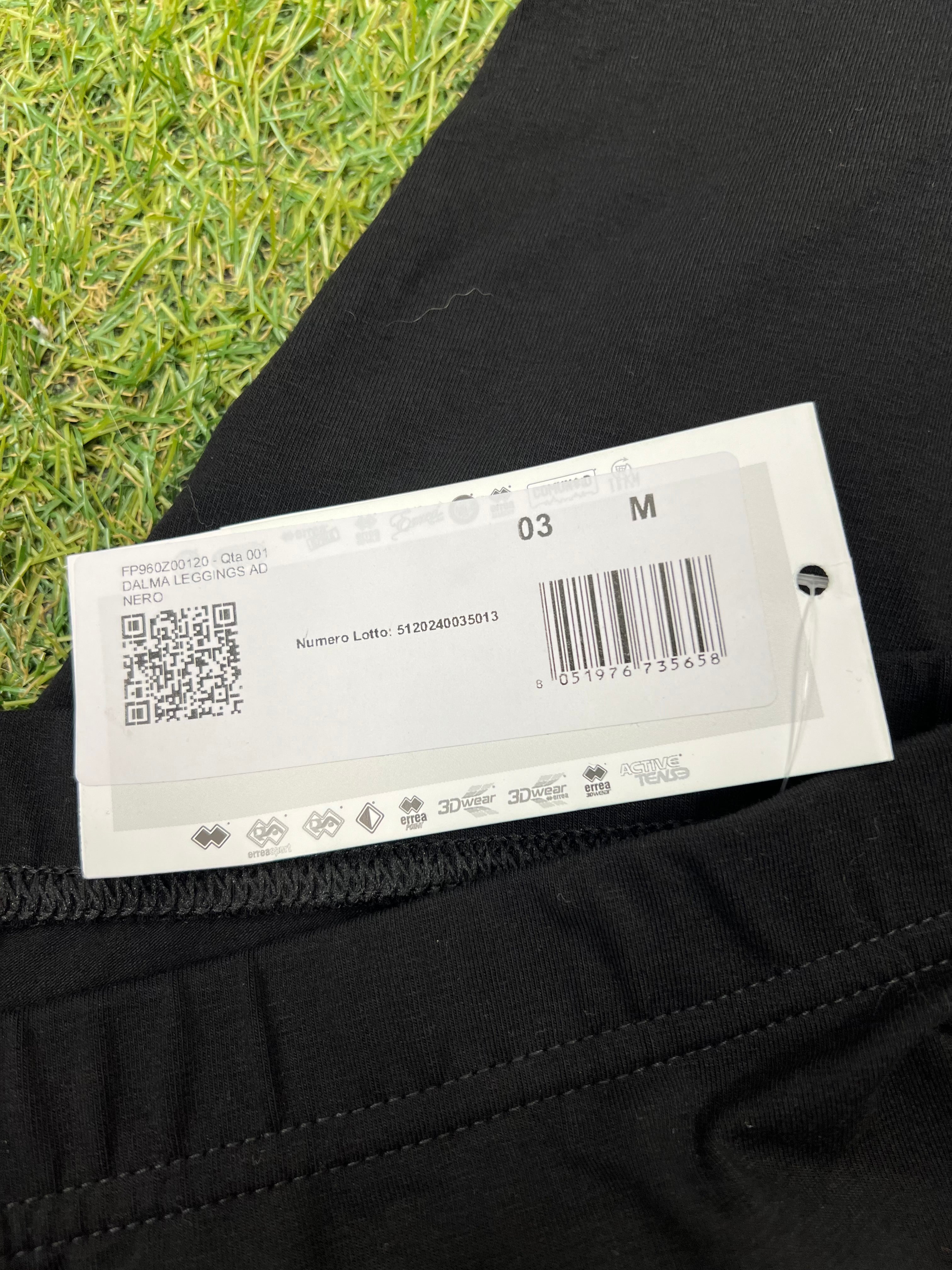 Close-up of product tag showing size medium and product code on black leggings