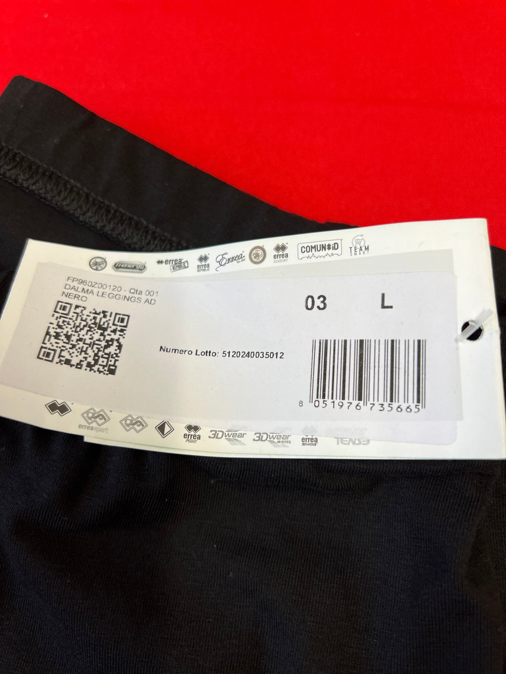 close-up of size L tag on black leggings with barcode and product details