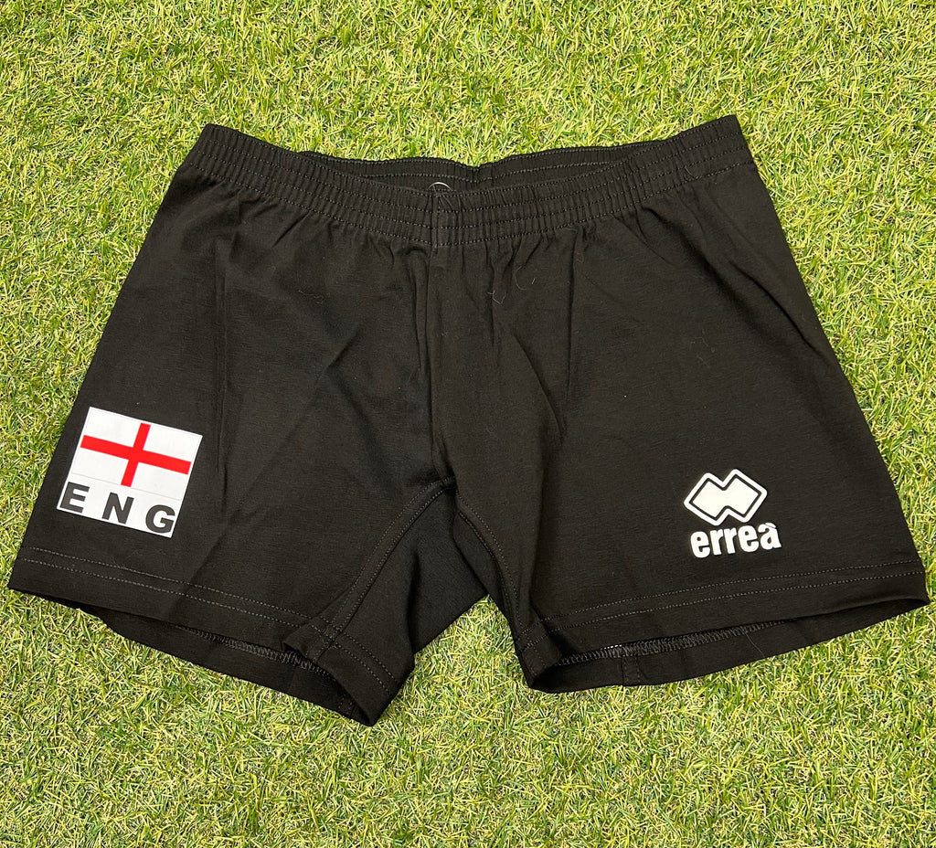 Front view of women’s volleyball shorts in black with England flag and Erreà logo on green grass