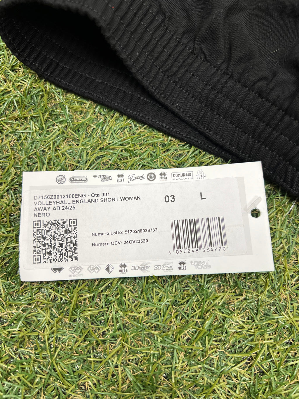 Close-up of product tag showing size L and description Volleyball England Short Woman Away AD 24/25