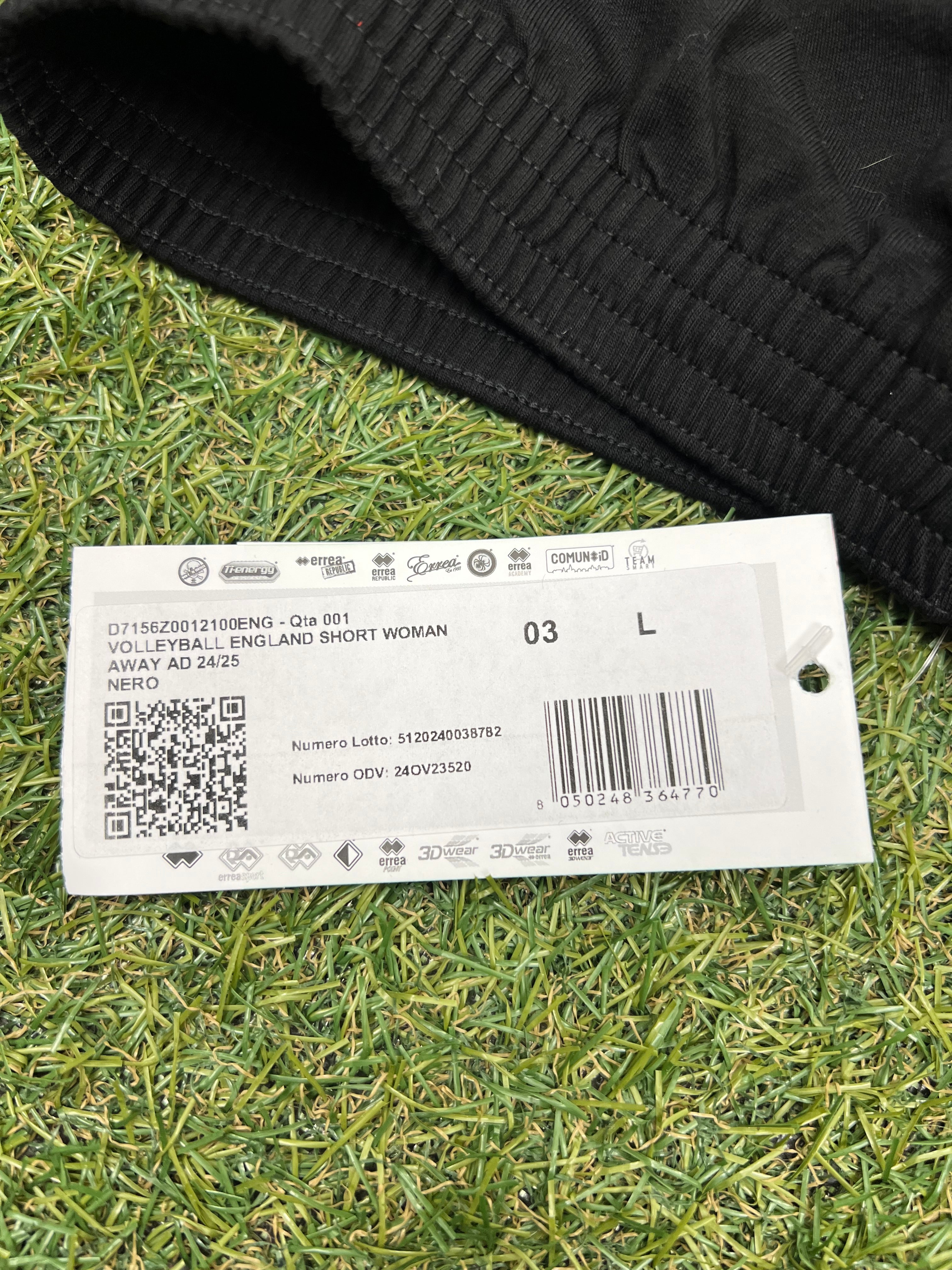 Close-up of product tag showing size L and description Volleyball England Short Woman Away AD 24/25
