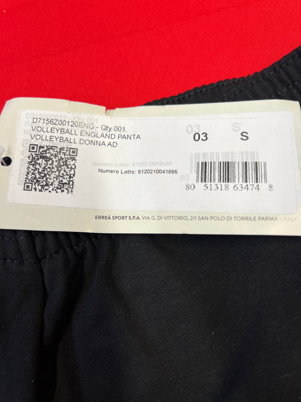 Close-up of product information tag for volleyball England black shorts size S