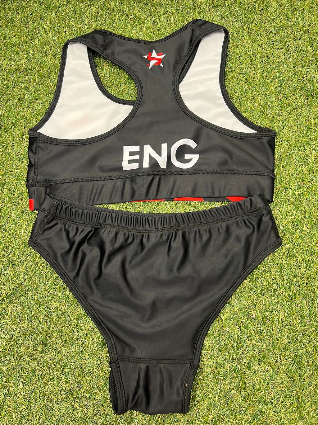 Back view of women's black Team England beach volleyball bikini showing racerback top and plain bottoms