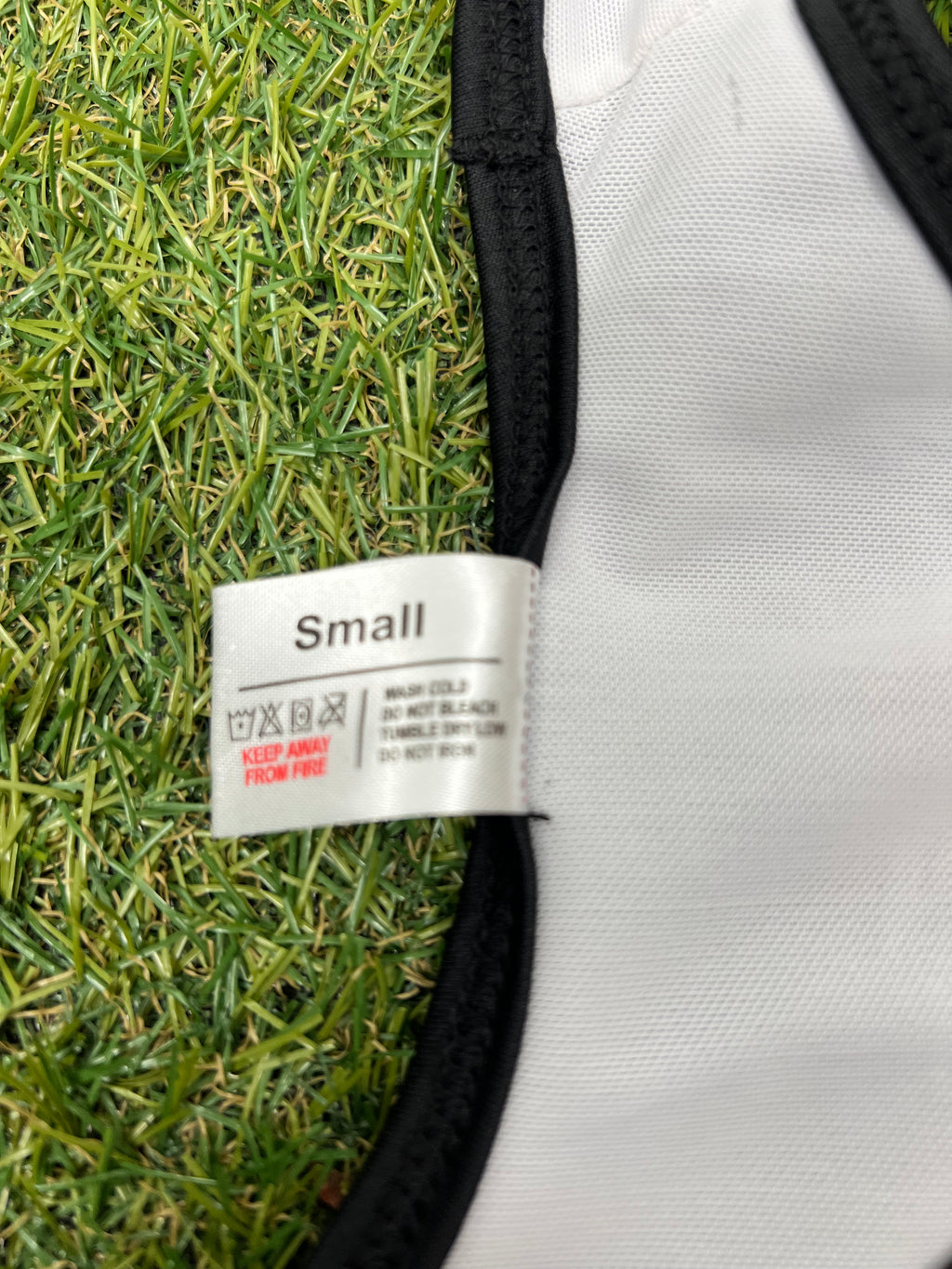 Close-up of size label sewn inside the bikini showing 'Small' size and washing instructions