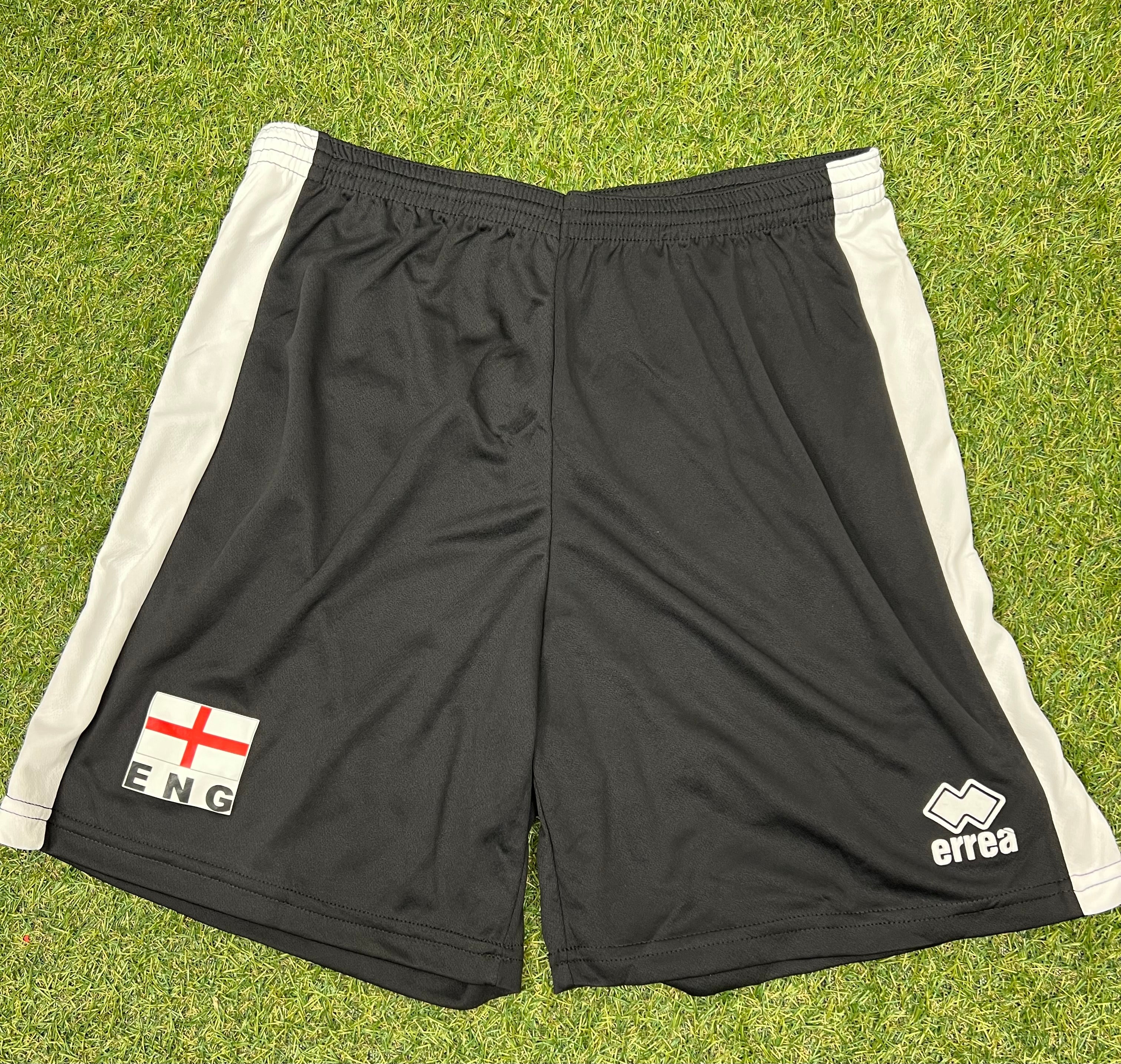 Black men’s volleyball shorts with white side stripes, England flag patch and Erreà logo on front