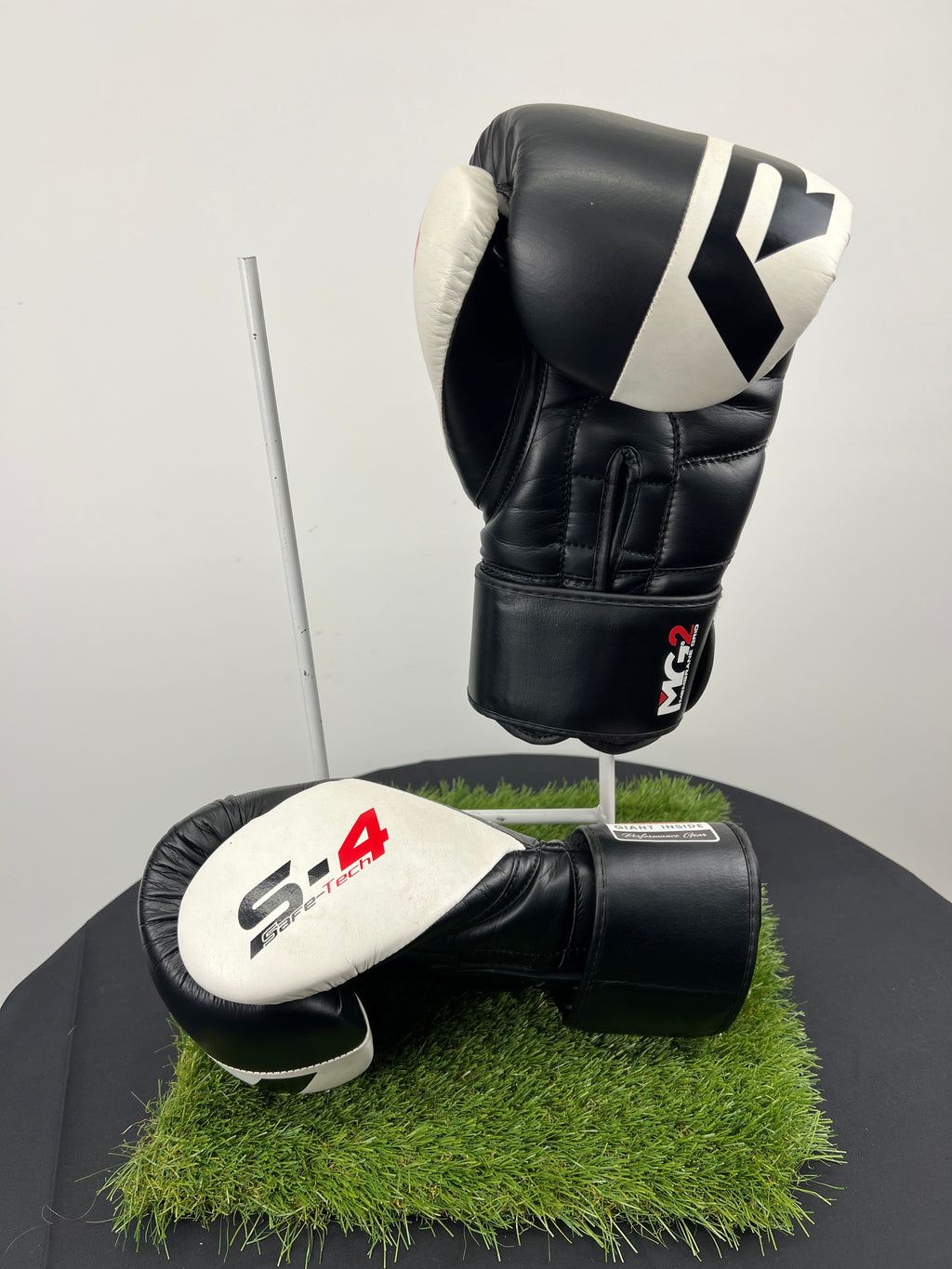 Side and top view of RDX Safe-Tech 4 boxing gloves highlighting the padding and secure wrist closure