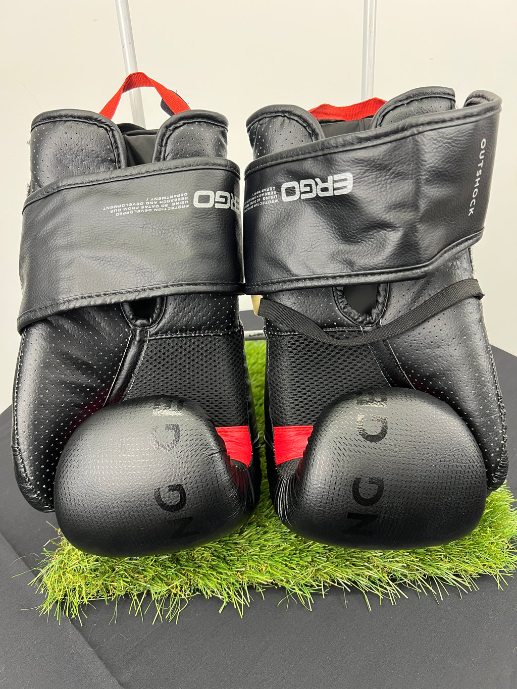 Back view of Outshock boxing gloves showing padded knuckles, mesh detailing and wrist straps