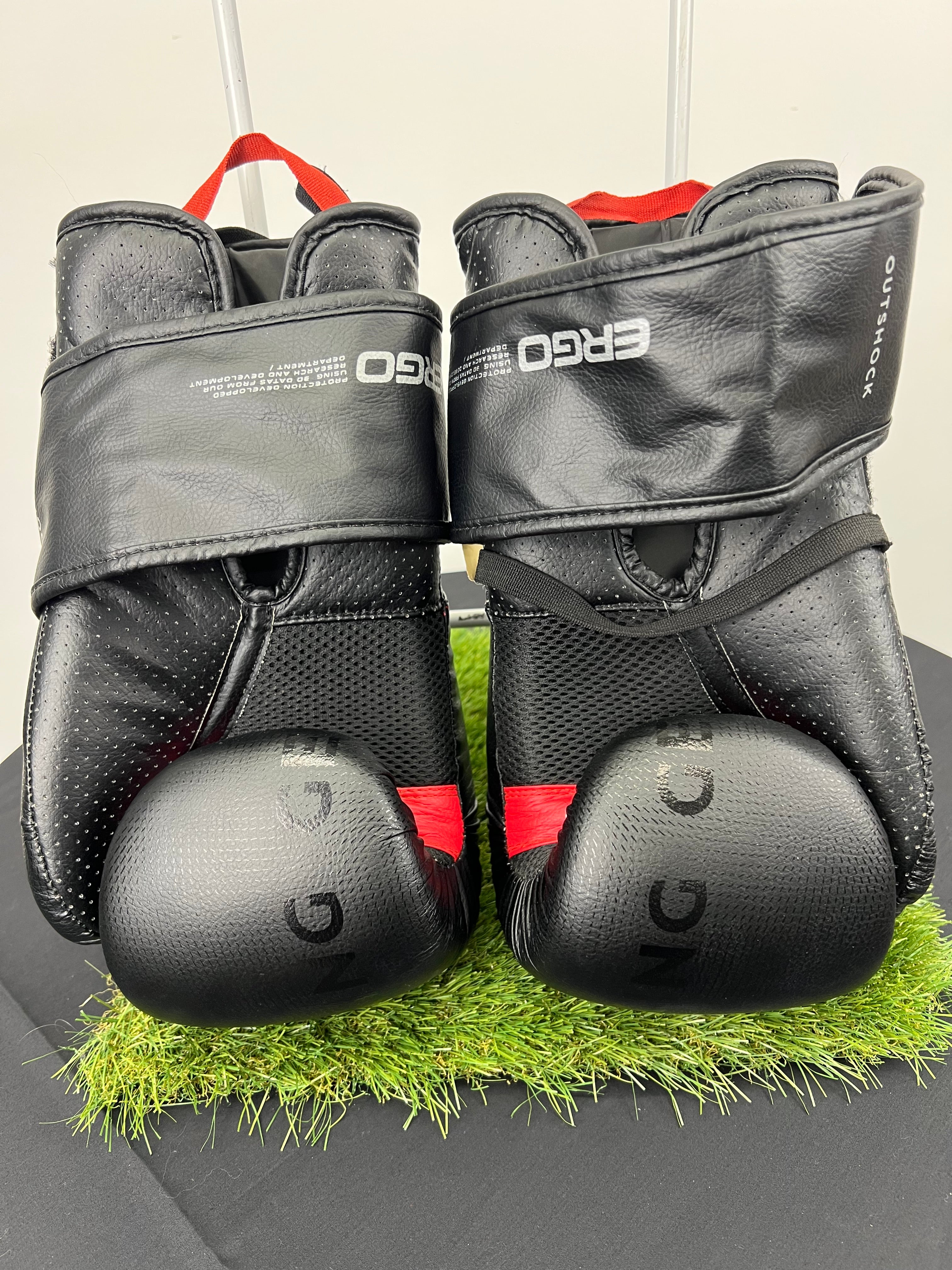 Back view of Outshock boxing gloves showing padded knuckles, mesh detailing and wrist straps