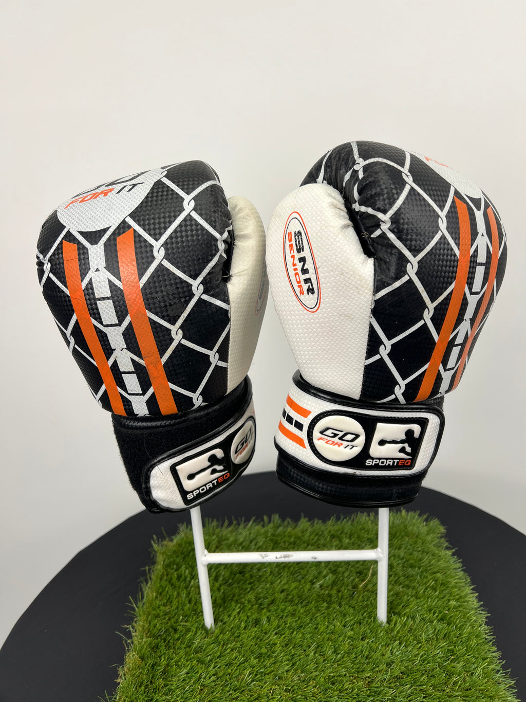 Front view of Sport EQ 10oz boxing gloves with black and white chain-link pattern and orange stripes