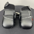Pair of black Outshock grappling gloves with padded knuckles and Velcro wrist straps viewed from the top