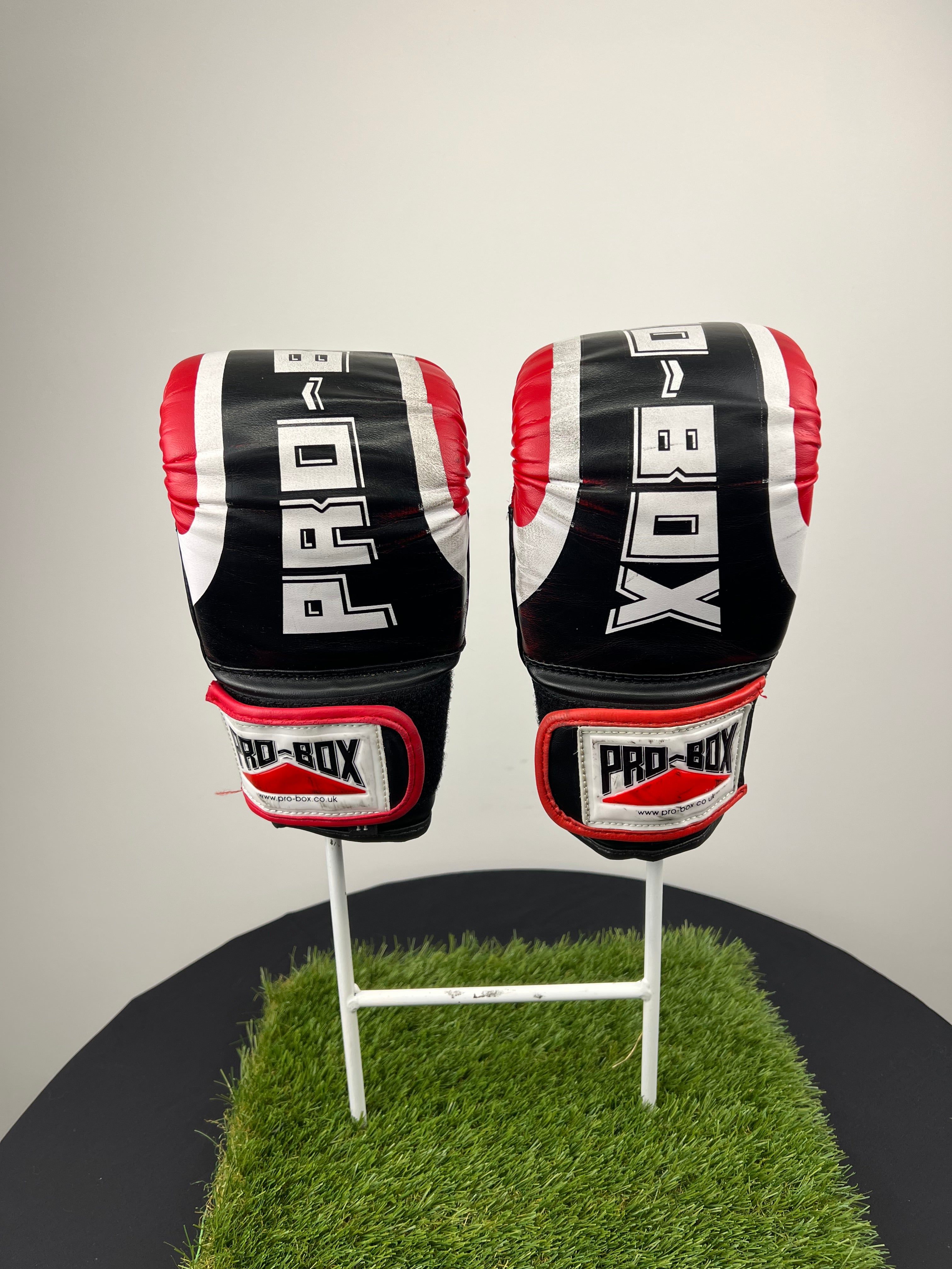 Front view of Pro Box boxing gloves size medium in black, red and white with bold 'PRO-BOX' print