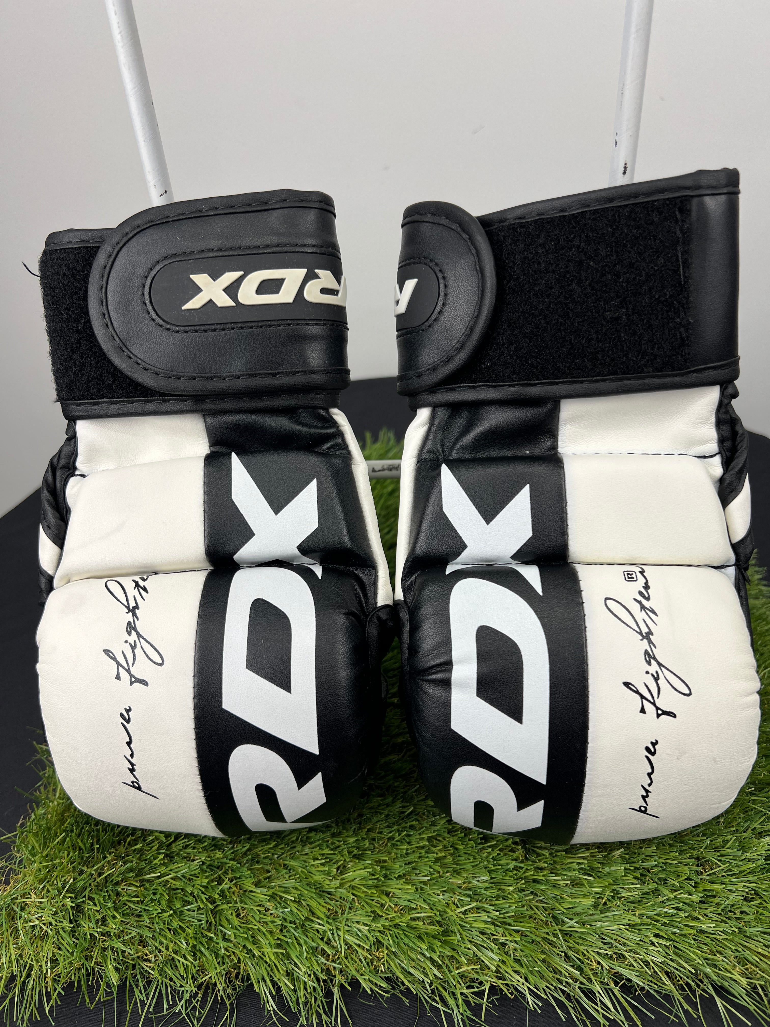 Front view of RDX T6 7oz MMA grappling gloves in black and white with RDX branding