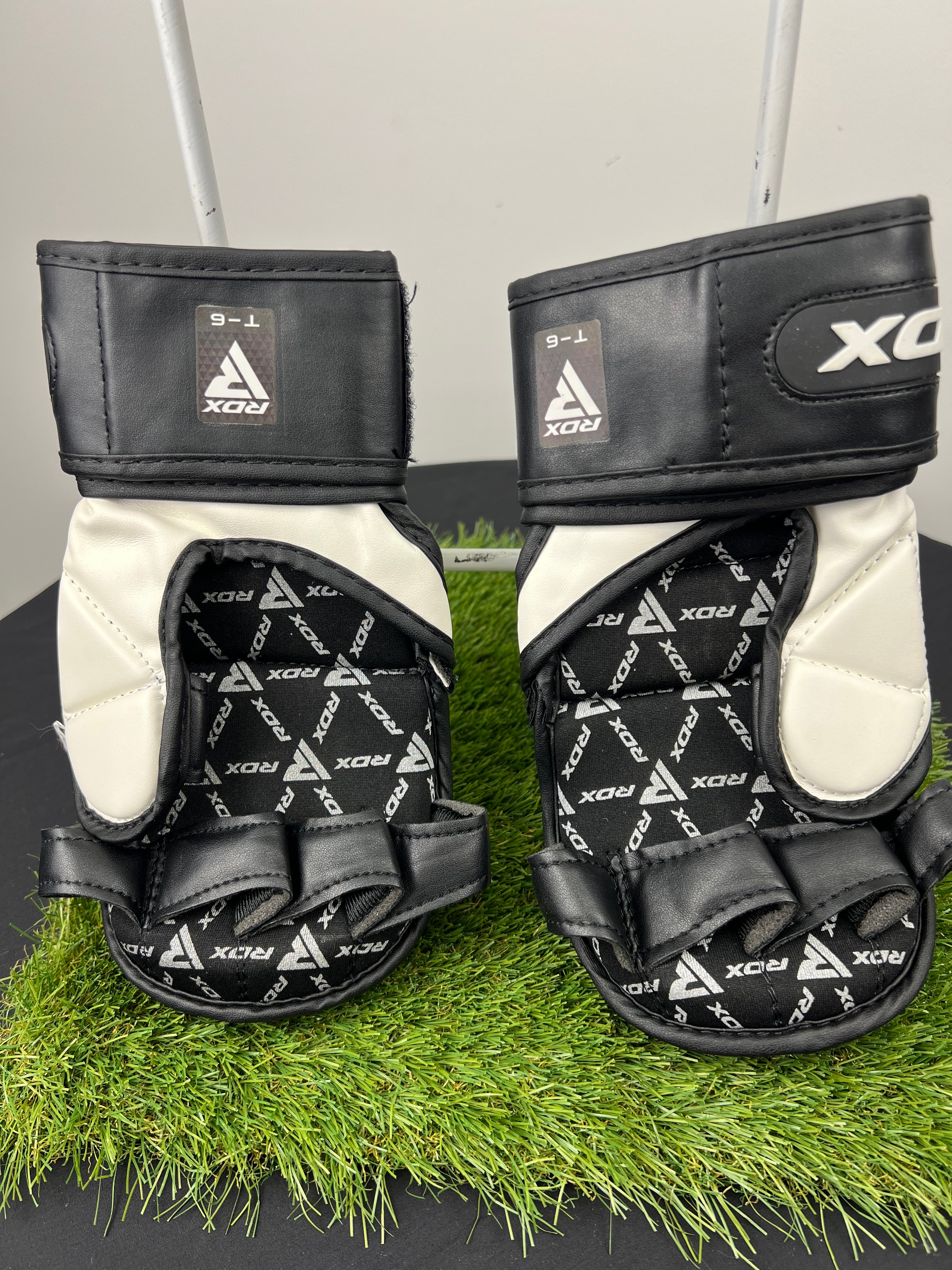 Back view of RDX T6 7oz MMA grappling gloves showing finger loops and Velcro wrist straps