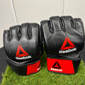 Pair of black Reebok open palm grappling gloves showing front knuckle side with red and white logos